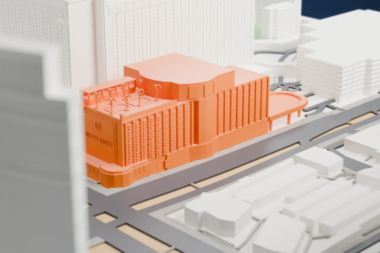 A white 3D print of The Vanderpump Hotel Las Vegas, a mid-rise casino hotel with a curved front and small palm-like shapes on its roof, beside a wide boulevard and among taller buildings.