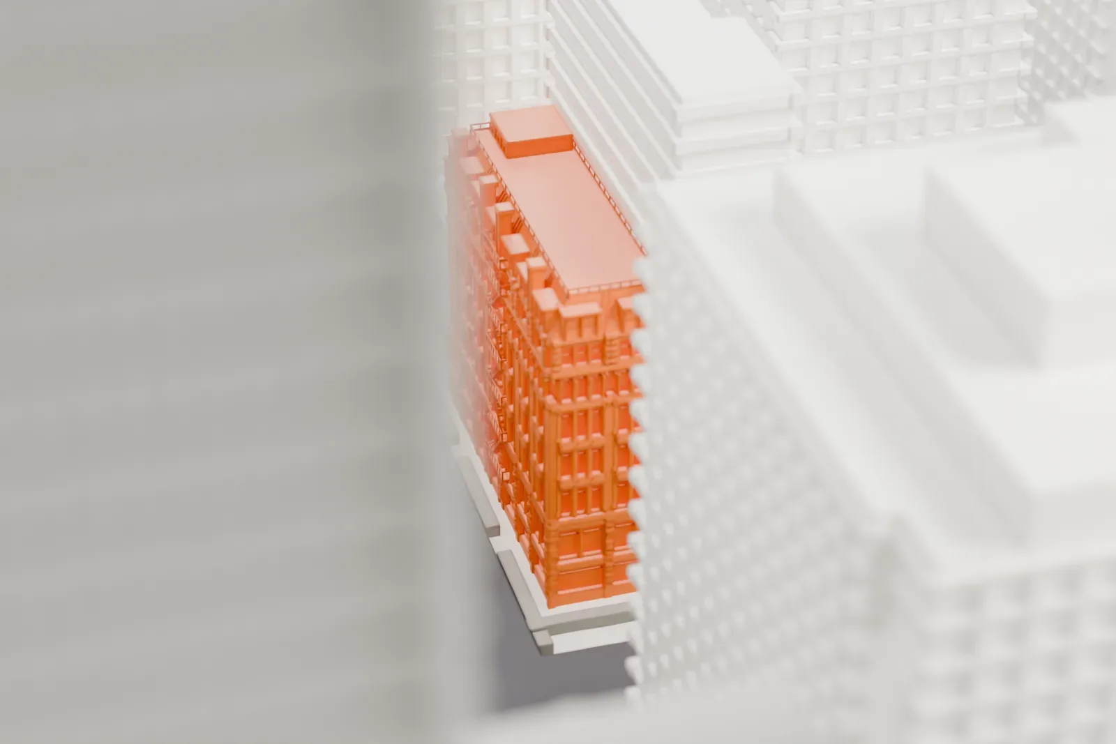 A white 3D print of The Wilbraham, a narrow, ornate building with a mansard roof, squeezed between much taller buildings on a city block.