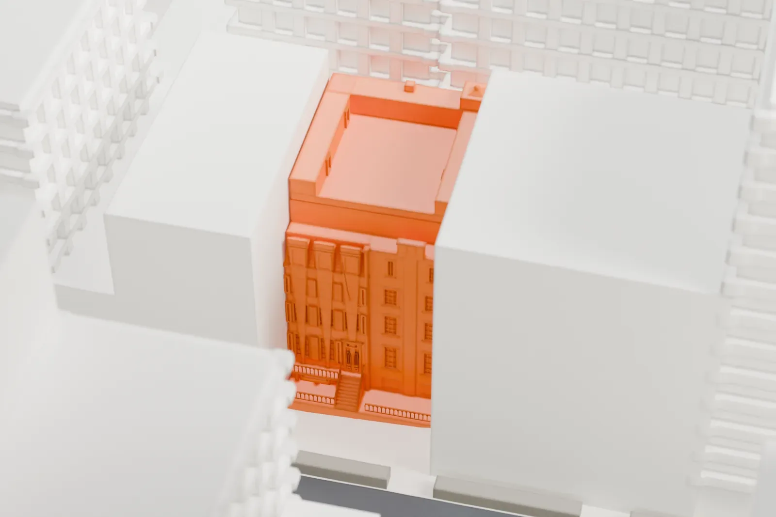 A white 3D print of the Theodore Roosevelt Birthplace, a small building among tall Manhattan blocks with a patch of park nearby.