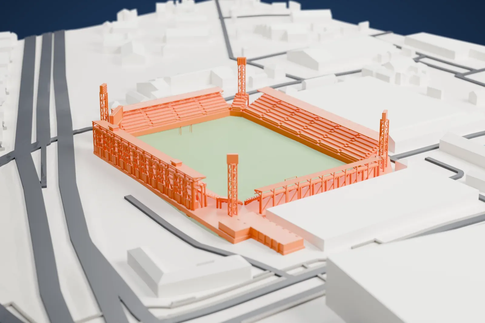 A white 3D print of Thunderdome Stadium, four separate stands around an open pitch with a taller main stand and tall light towers, among surrounding buildings.