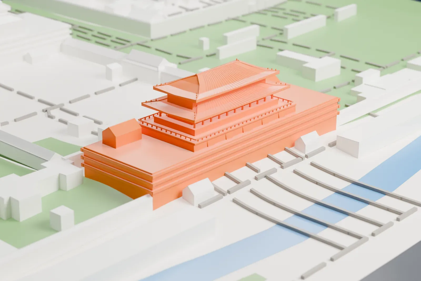 A white 3D print of Tiananmen Gate, a wide gatehouse with two tiers of tiled hip roofs on a broad base, set beside a strip of water and low buildings.