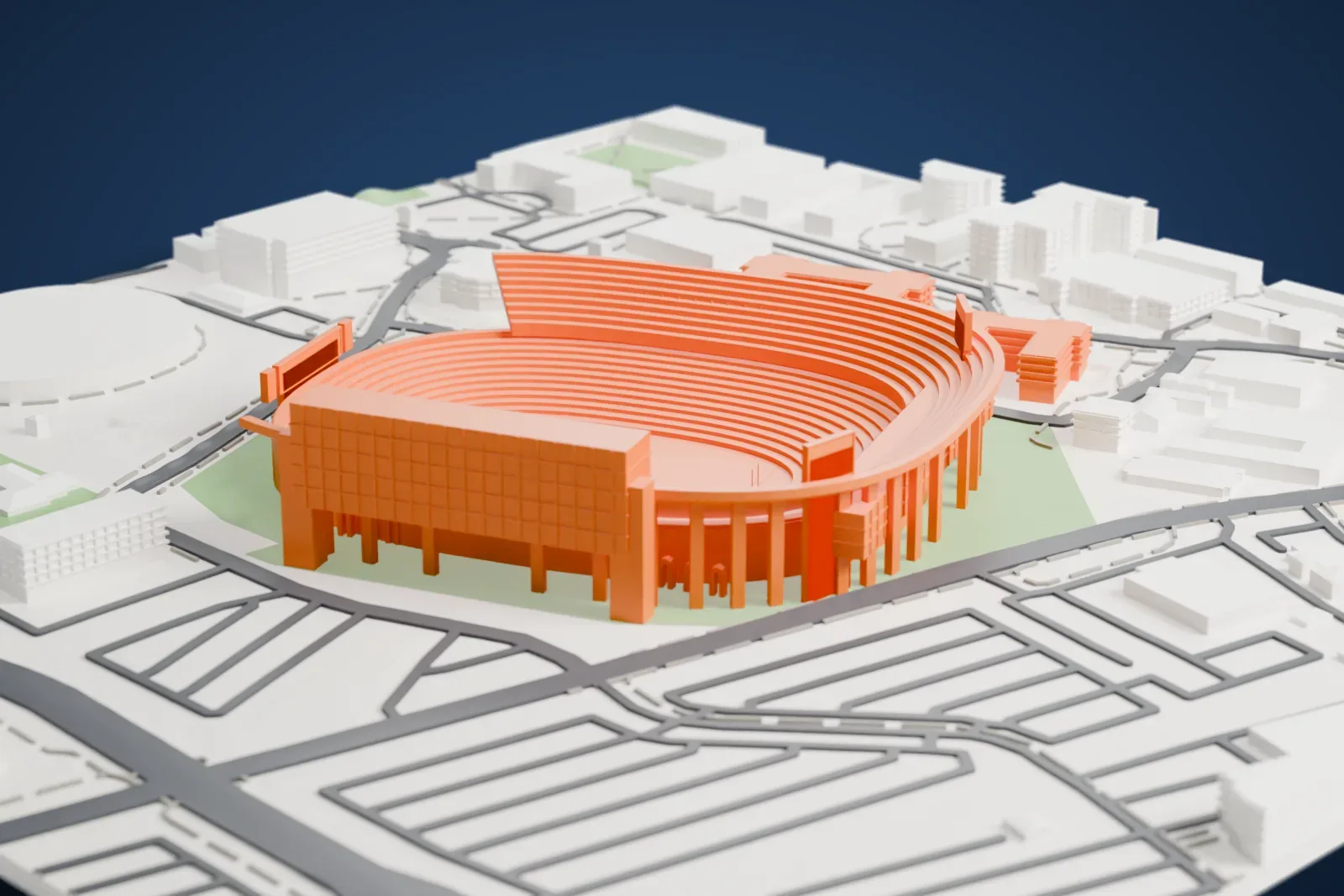 A white 3D print of Tiger Stadium, an oval bowl of tiered seating with a tall block on one side, surrounded by streets, small buildings, a large round building and patches of green.