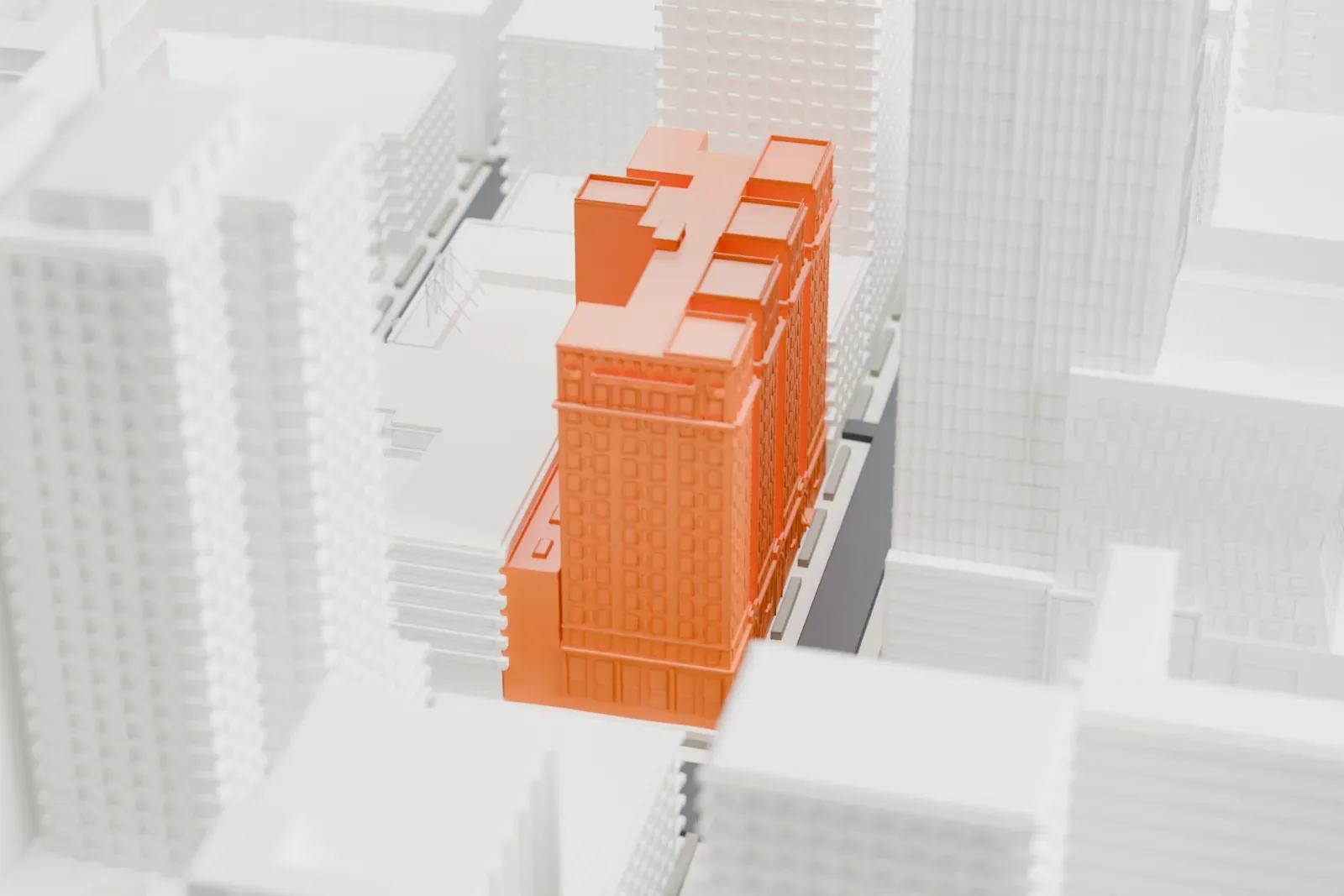 A white 3D print of the Times Square Hotel, a tall block with several wings topped by small pointed gables, surrounded by skyscrapers.
