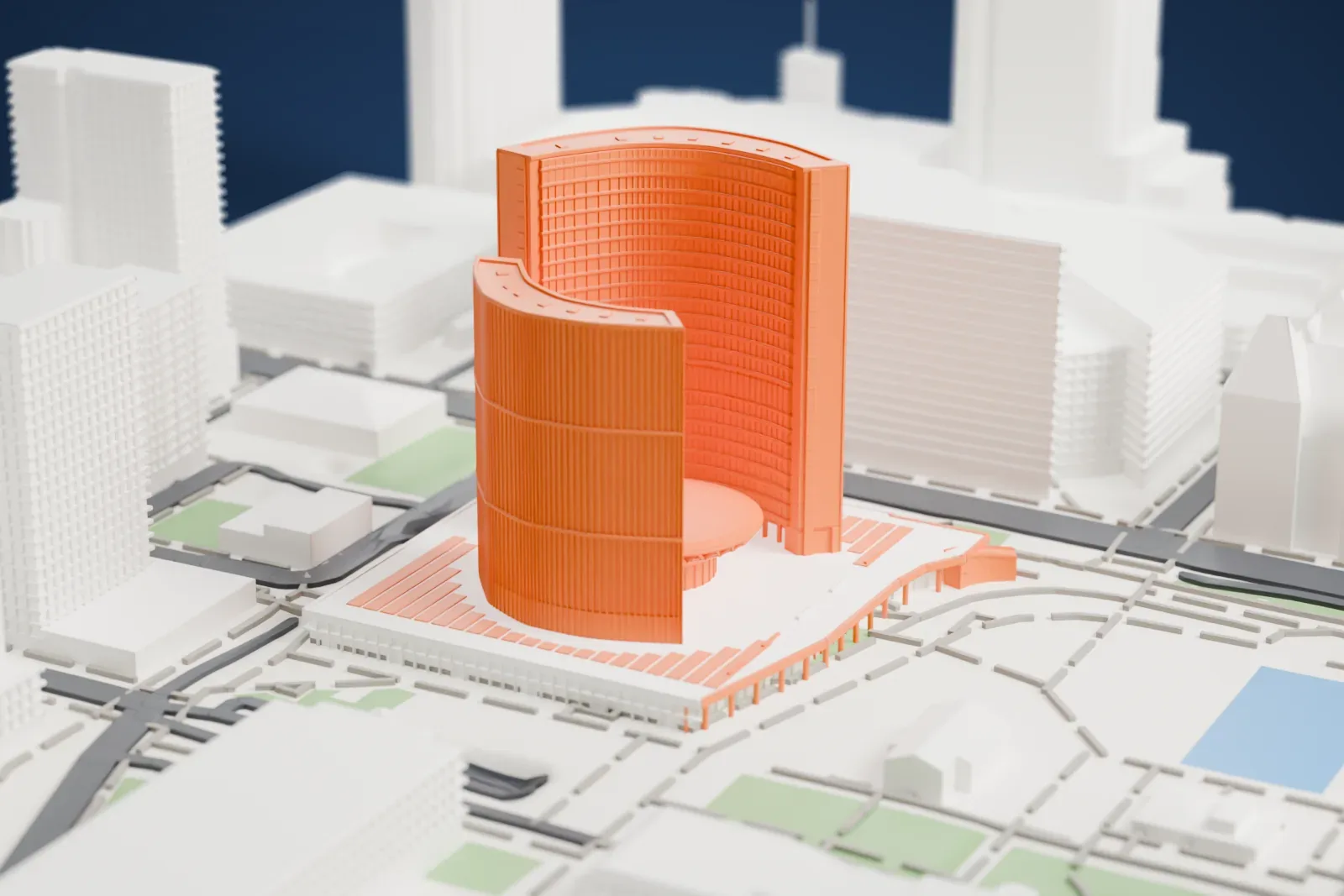 A white 3D print of Toronto City Hall, two tall curved towers of different heights facing each other on a wide podium, with open space, a pool and taller buildings around it.
