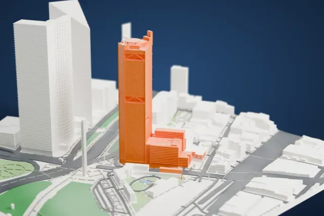 A white 3D print of the Torre BBVA model in Mexico City, with the streets around it.