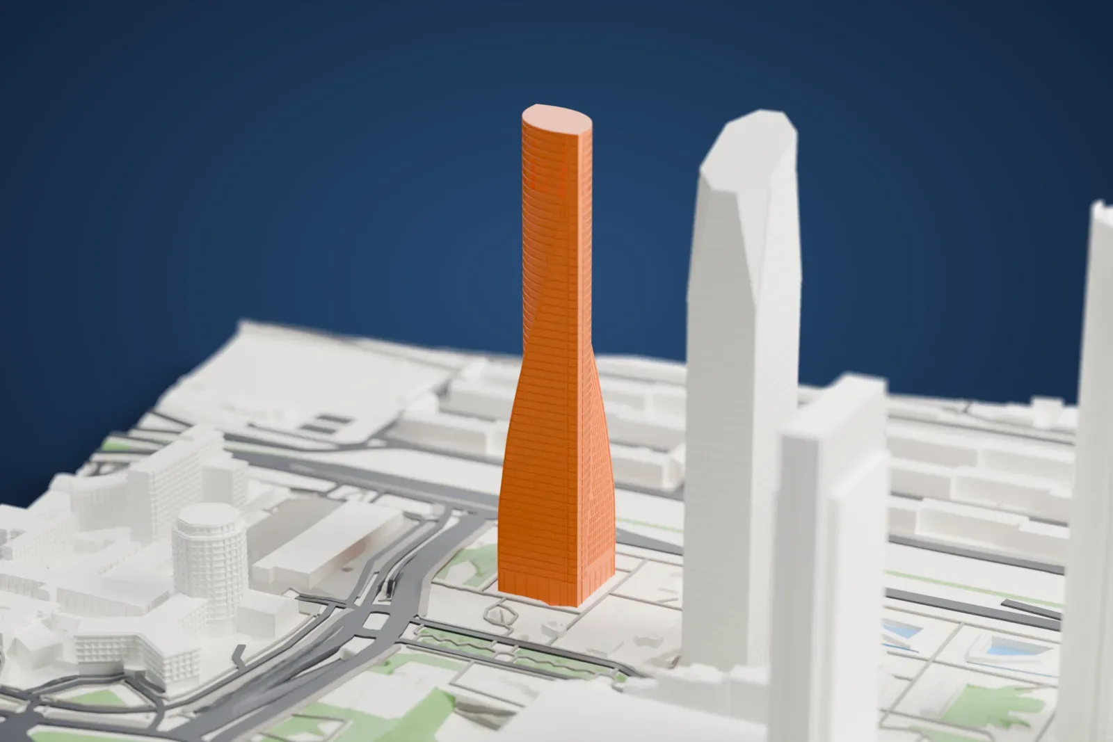 A white 3D print of Torre Emperador, a tall office tower, standing among surrounding streets and buildings.