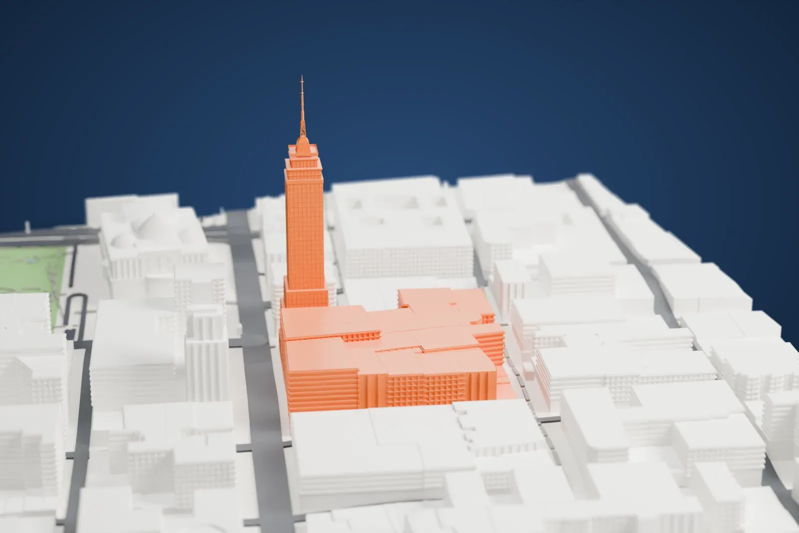 A white 3D print of the Torre Latinoamericana, a slender stepped tower with a thin spire, standing among city blocks, streets and a green open space with a domed building nearby.