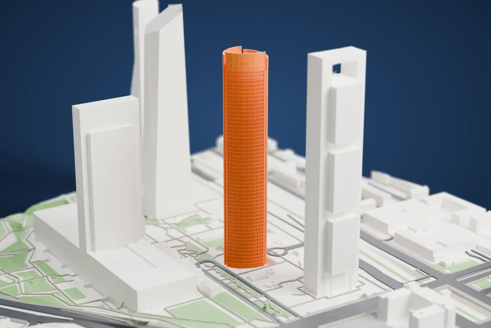 A white 3D print of the Torre PwC with its curved glass facade, standing among the surrounding streets and buildings.