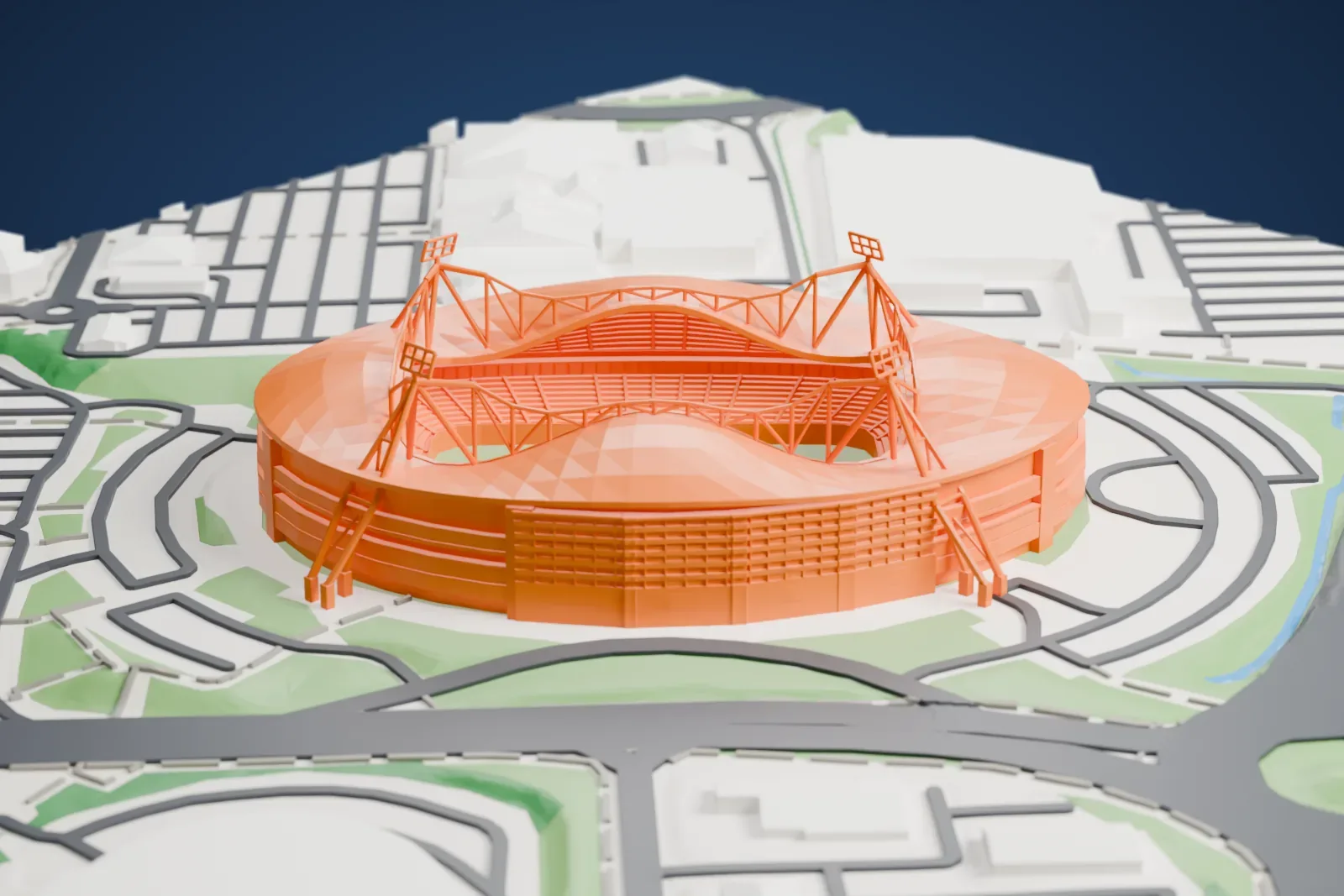 A white 3D print of the Toughsheet Community Stadium, an oval two-tier bowl with a roof that humps over each stand and four leaning corner masts carrying floodlight frames, among the surrounding streets and buildings.