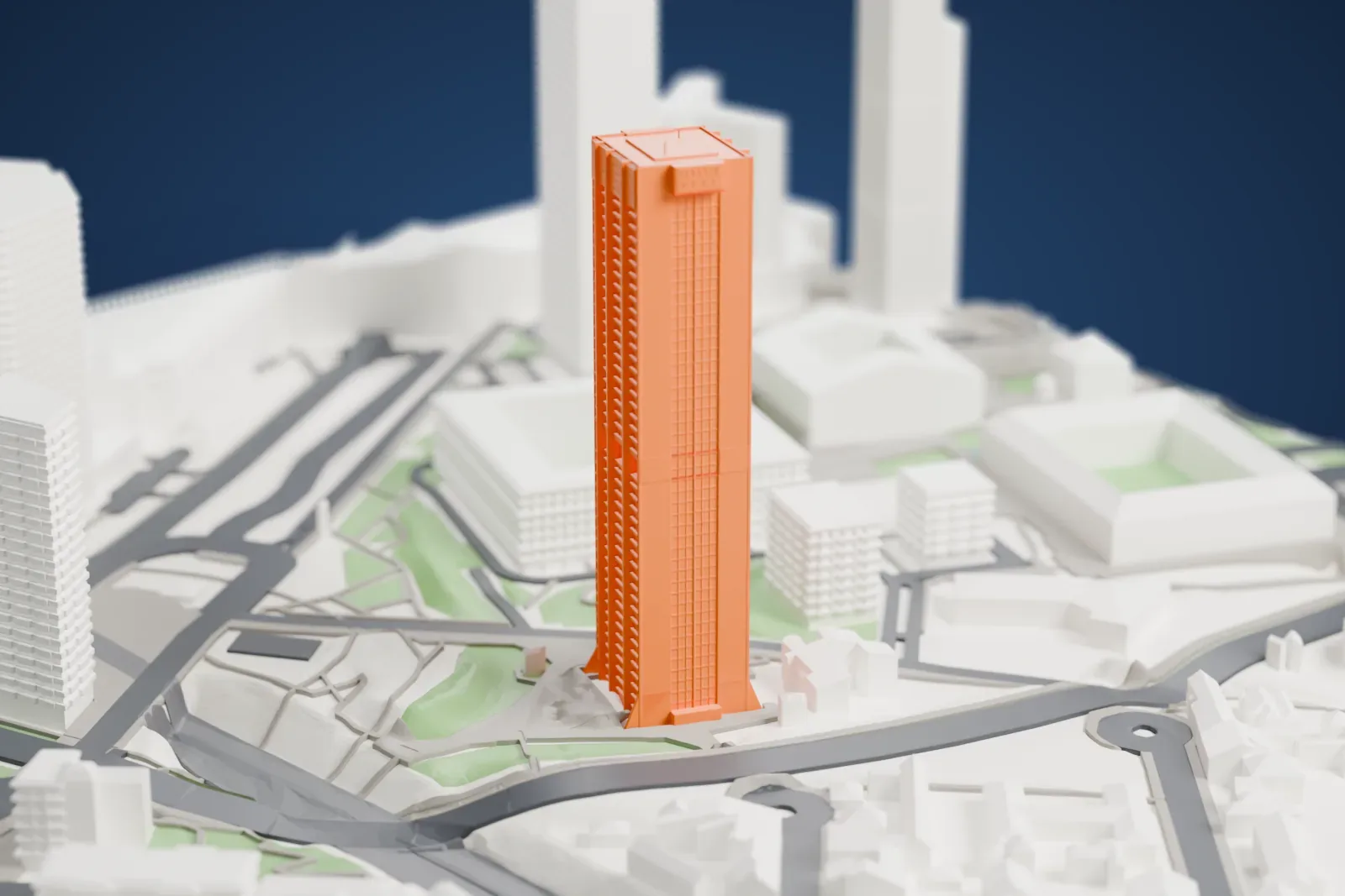 A white 3D print of Tour Défense 2000, a tall residential tower among surrounding streets and buildings.