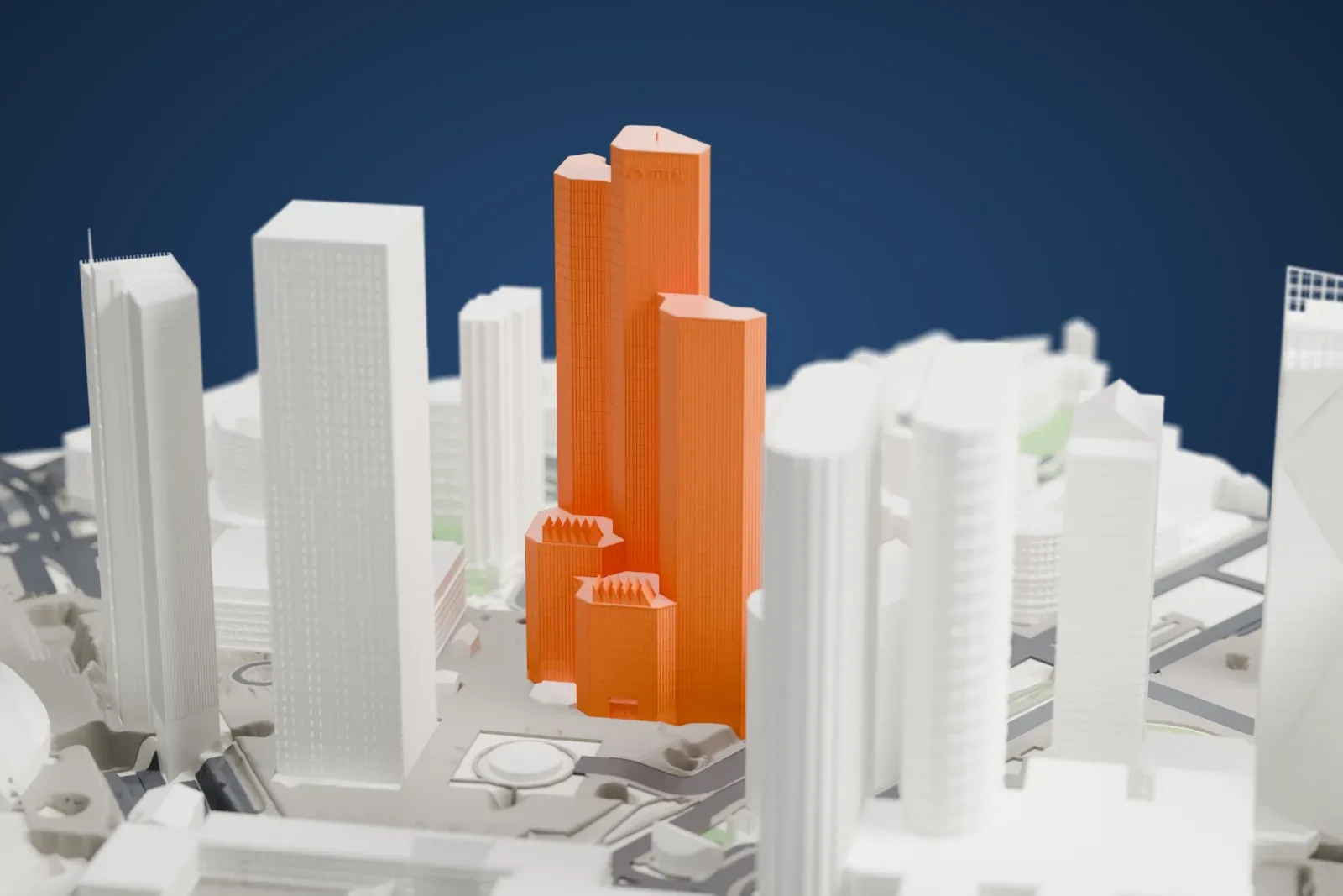 A white 3D print of Tour Total, a tall skyscraper, surrounded by streets and buildings.