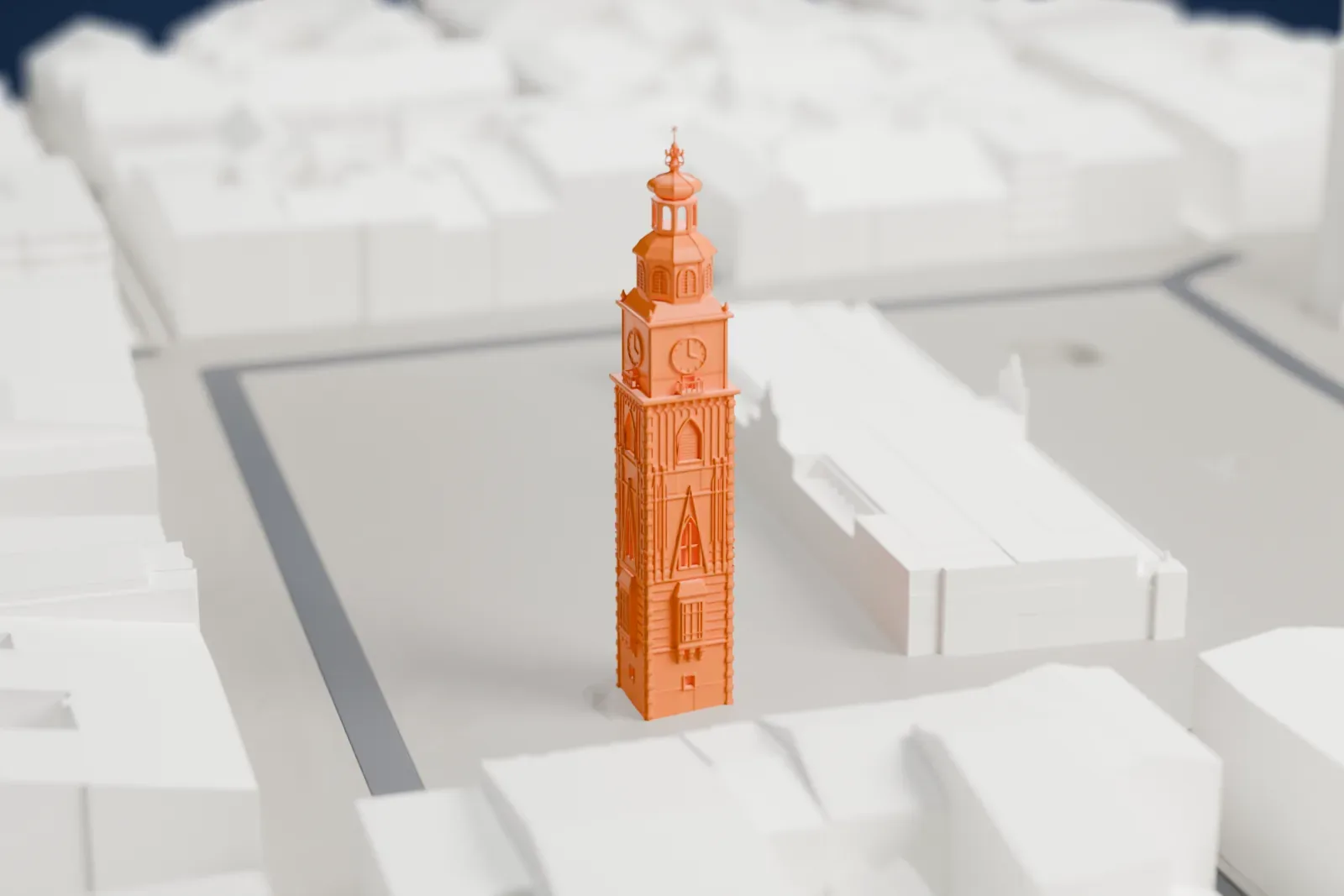 A white 3D print of the Town Hall Tower with the surrounding streets and buildings of Kraków.