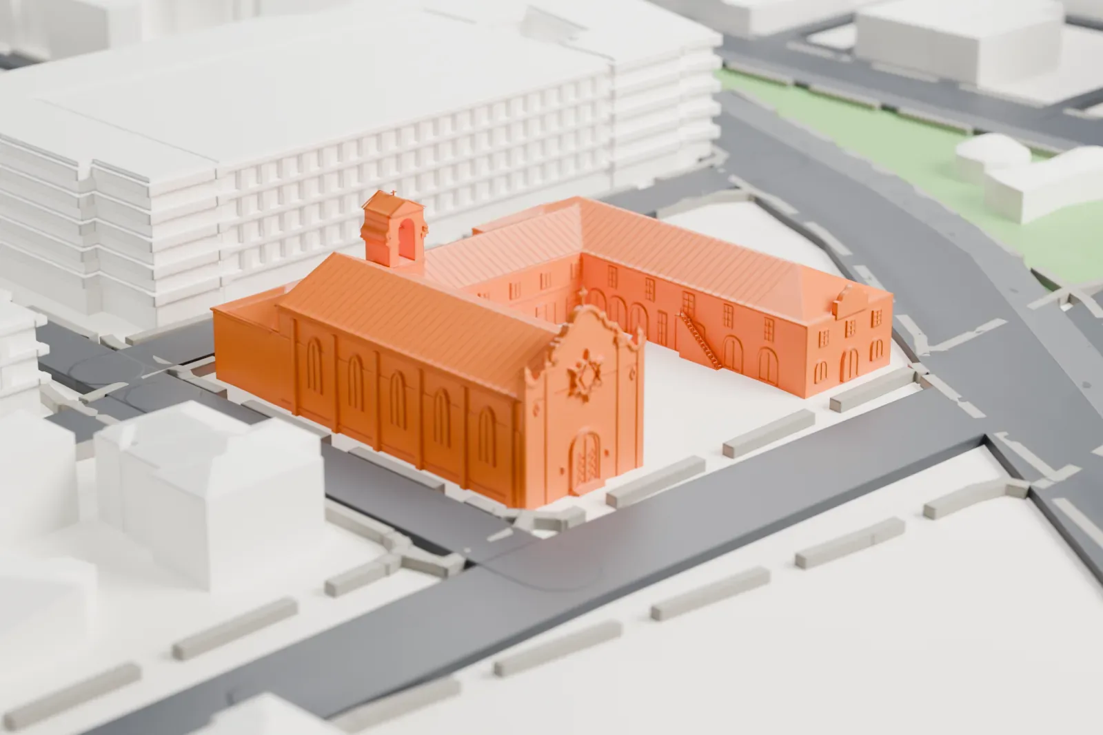 A white 3D print of Trinity Cathedral, a group of steep-roofed buildings with a small bell tower around an open courtyard, among streets and larger buildings.