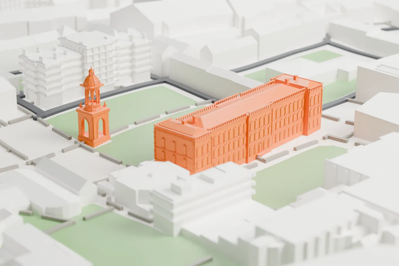 A white 3D print of Trinity College Dublin, a long college building and a separate domed tower, set among green squares, paths and streets.