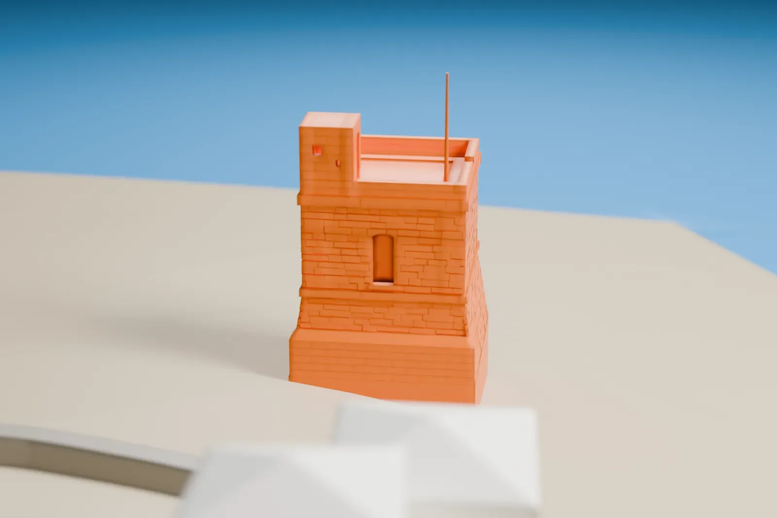 A white 3D print of Triq il-Wiesgħa Tower, a small square watchtower with a sloped base, a small turret and a thin pole on its roof, standing on open ground beside the water.