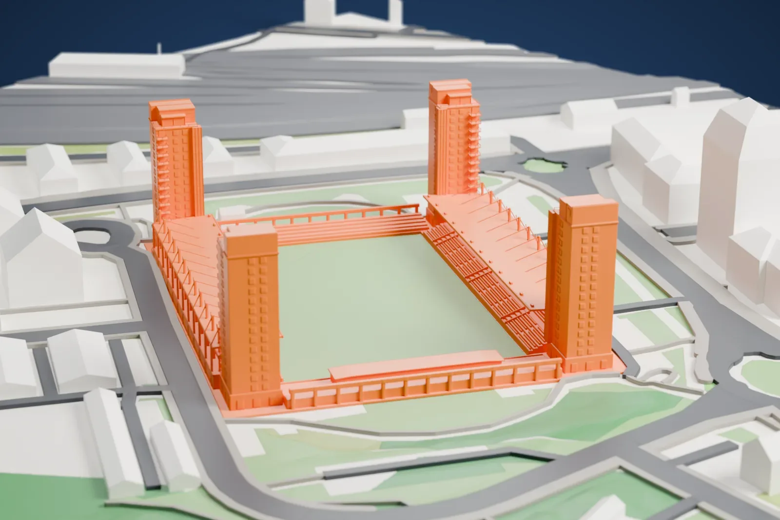A white 3D print of Tunavallen, an open pitch with long stands and four tall corner towers, among the surrounding streets and buildings.