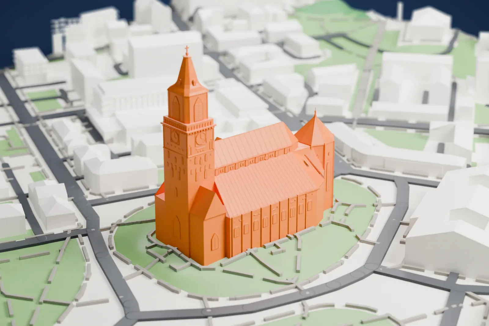A white 3D print of Turku Cathedral, a long church with a tall steepled tower at one end, standing in green parkland near a river with city buildings around it.
