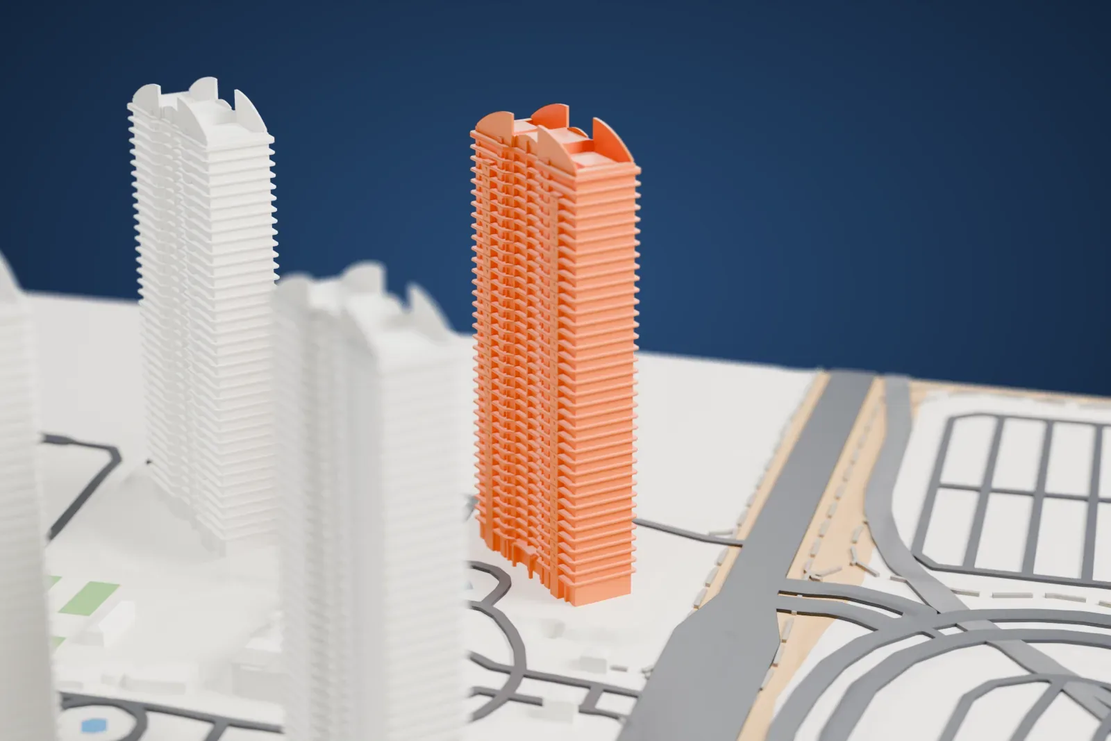 A white 3D print of Turnberry Place, four tall towers with stacked ledges and curved tops around a group of low buildings, beside wide roads.