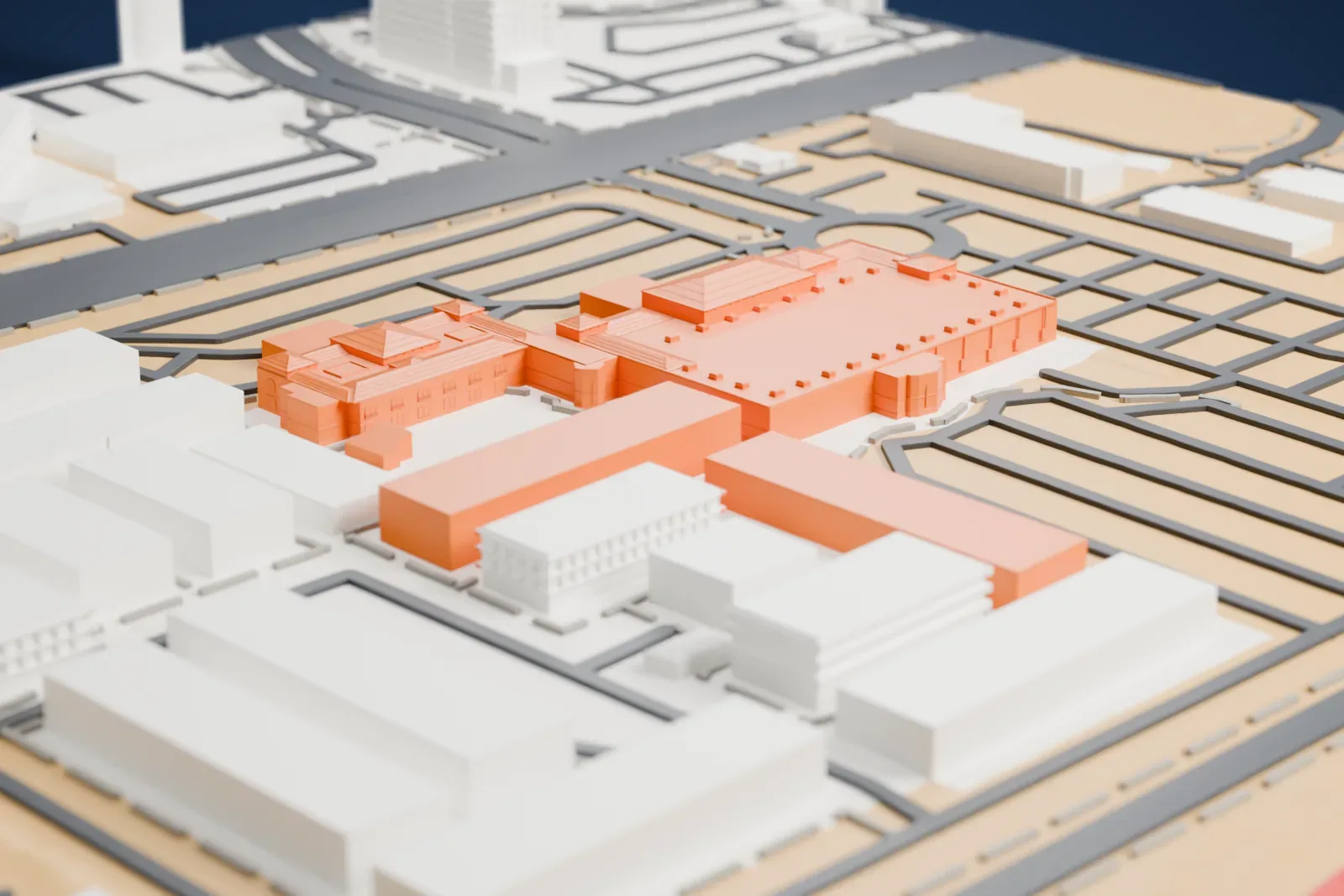A white 3D print of Tuscany Suites and Casino, a group of low, wide buildings with hipped roofs, surrounded by parking lots, roundabouts and roads.