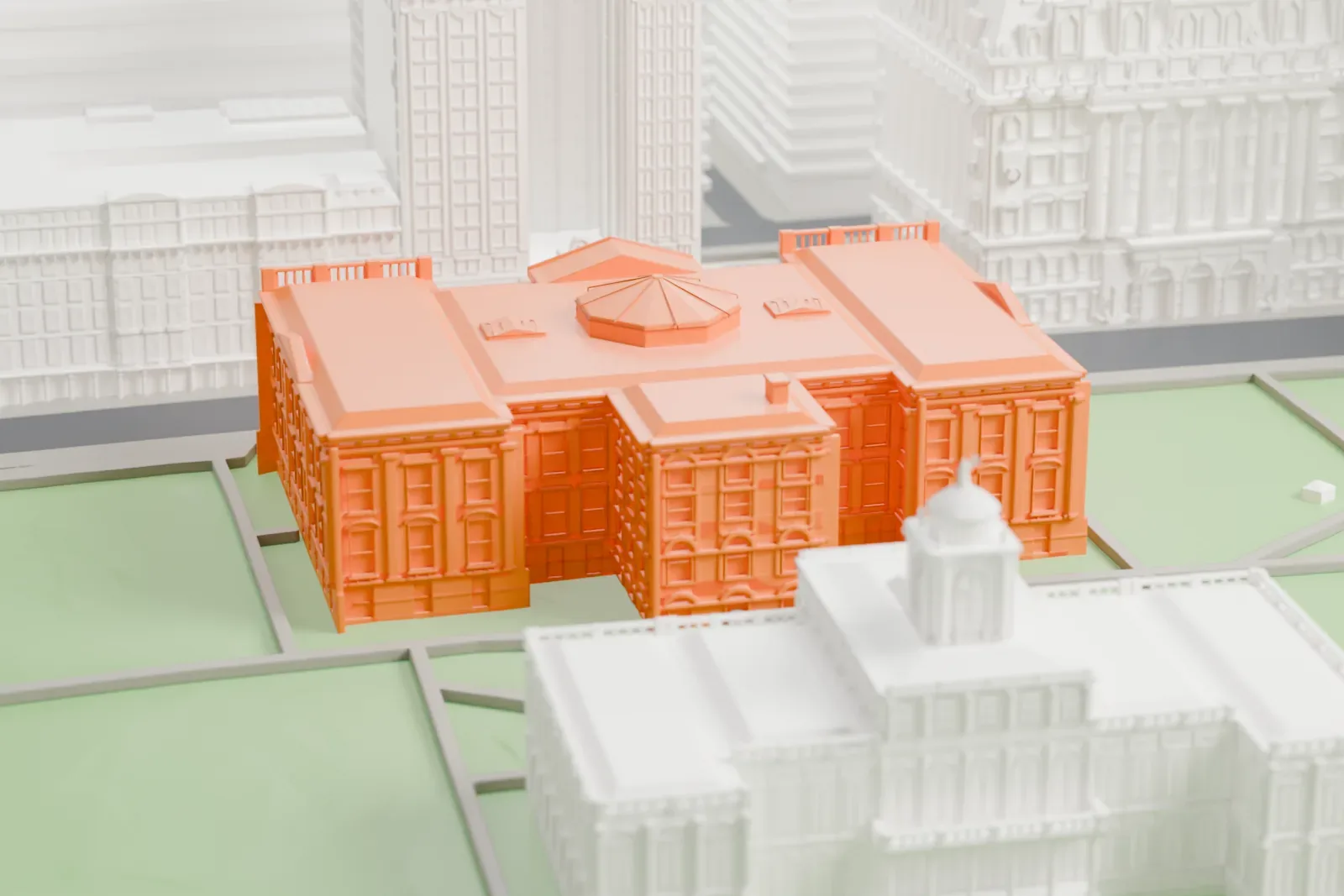A white 3D print of the Tweed Courthouse, a low building with a small rooftop cupola, standing among park lawns with taller buildings around it.