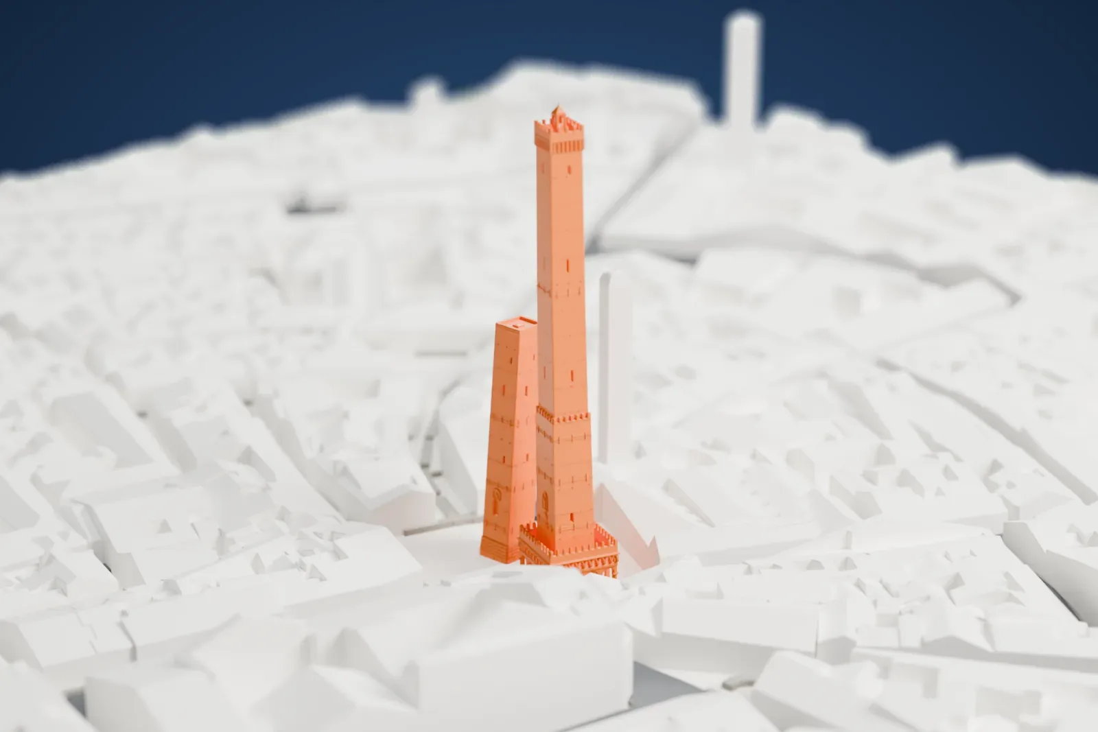 A white 3D print of the Two Towers of Bologna, a tall slender tower with a battlemented top beside a shorter tower, packed among dense city buildings and narrow streets.
