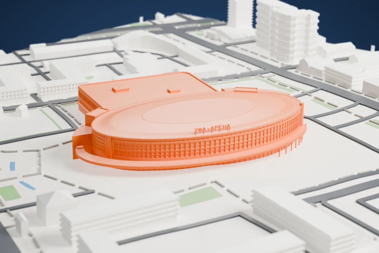A white 3D print of Ufa Arena, a wide elliptical drum with a shallow domed roof, a thin projecting entrance canopy and lettering along the roof edge, among surrounding streets and buildings.