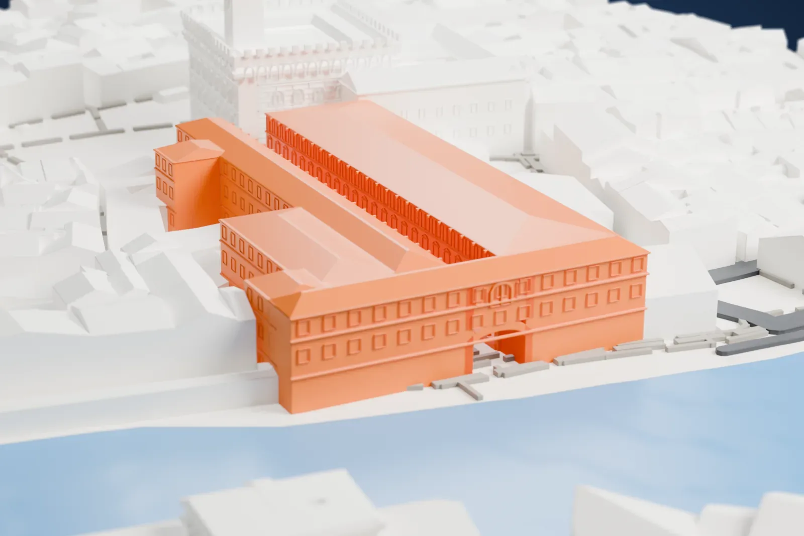 A white 3D print of the Uffizi Gallery, a U-shaped building of two long wings beside a river, next to a tall-towered building and dense city streets.