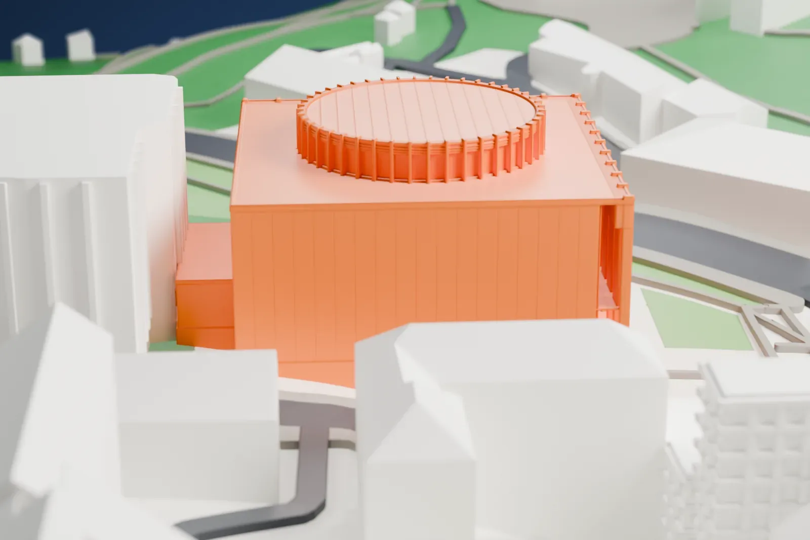 A white 3D print of the Ukrainian House, a square building with rows of narrow piers and a round lantern on its flat roof, among surrounding buildings and green areas.