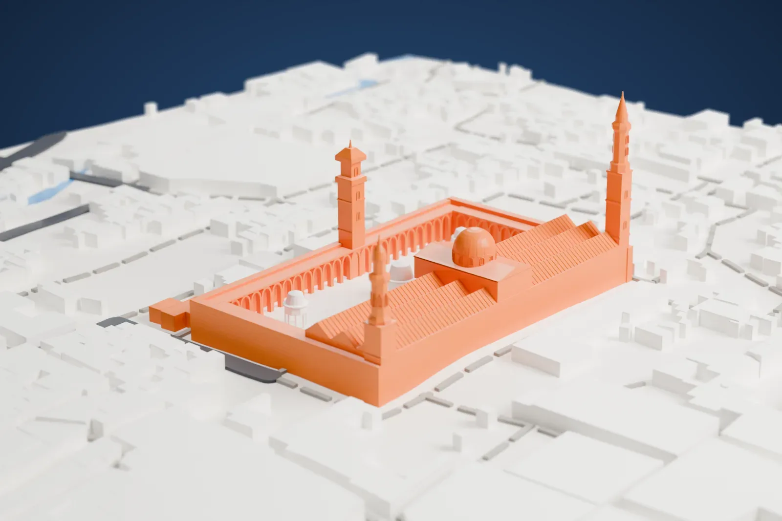 A white 3D print of the Umayyad Mosque, a walled rectangular courtyard with a long prayer hall, a central dome and three tall minarets, surrounded by dense low buildings.