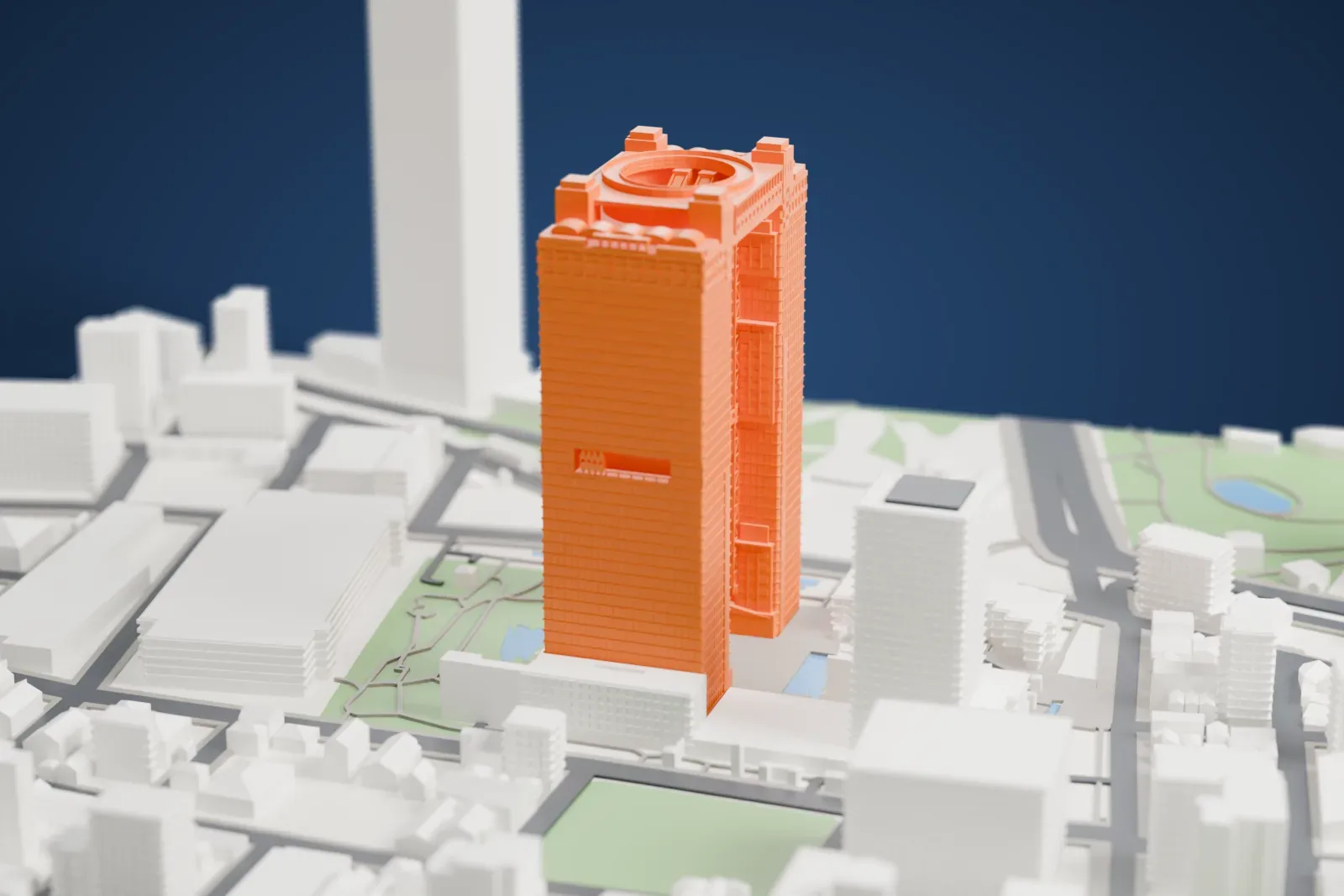 A white 3D print of the Umeda Sky Building, two tall towers joined by a rooftop deck with a round opening, among the surrounding streets and buildings of Osaka.