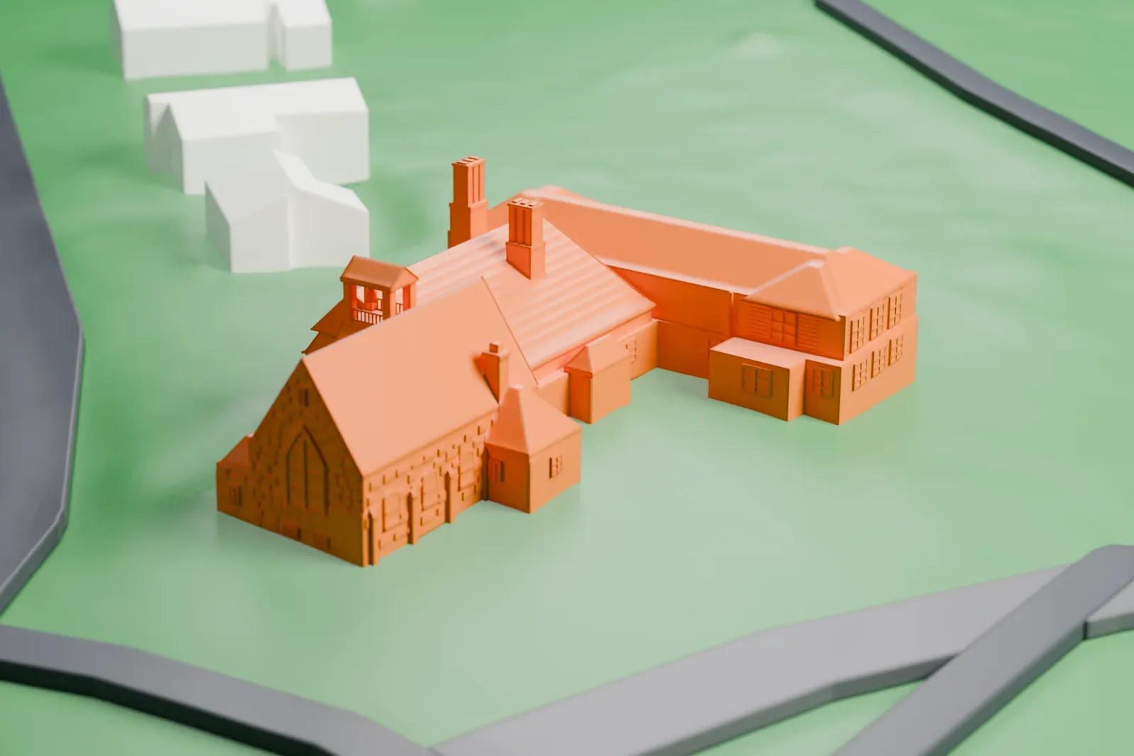 A white 3D print of Union Church of Pocantico Hills, a rambling building with steep gables, chimneys and a small bell tower, set on a lawn beside curving roads.