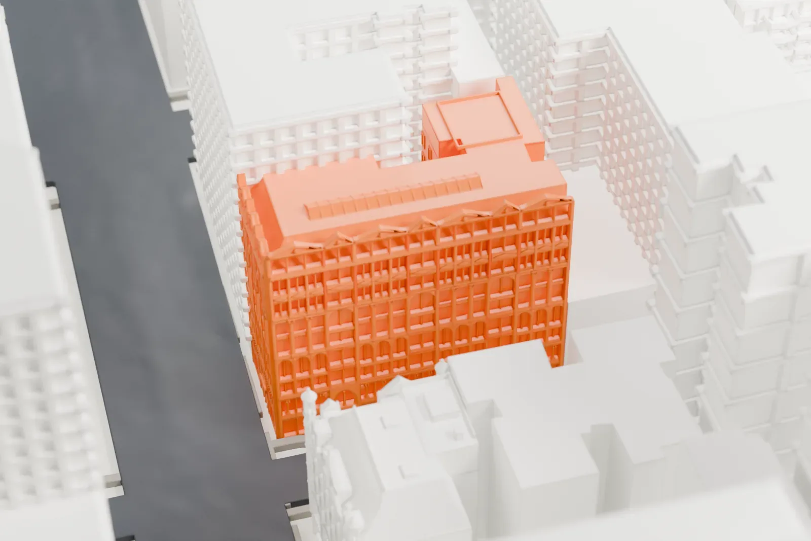 A white 3D print of the United Charities Building, an ornate gabled facade set among taller buildings in a dense city block.