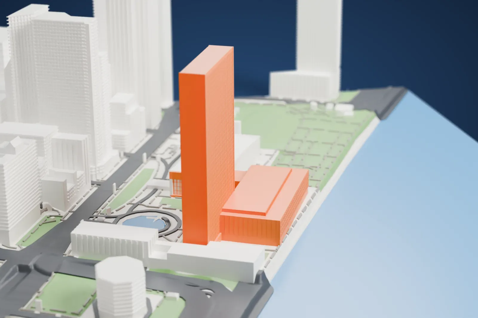A white 3D print of the United Nations Headquarters, a tall slab tower beside long low halls with a shallow dome, on the East River waterfront with city towers behind.