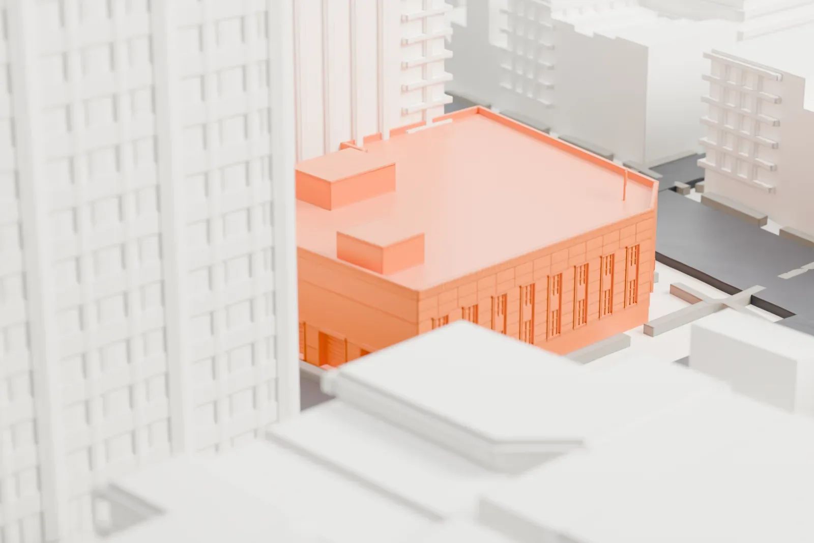 A white 3D print of the Canal Street Station post office, a wide low building with a flat roof, set among taller buildings and city streets.