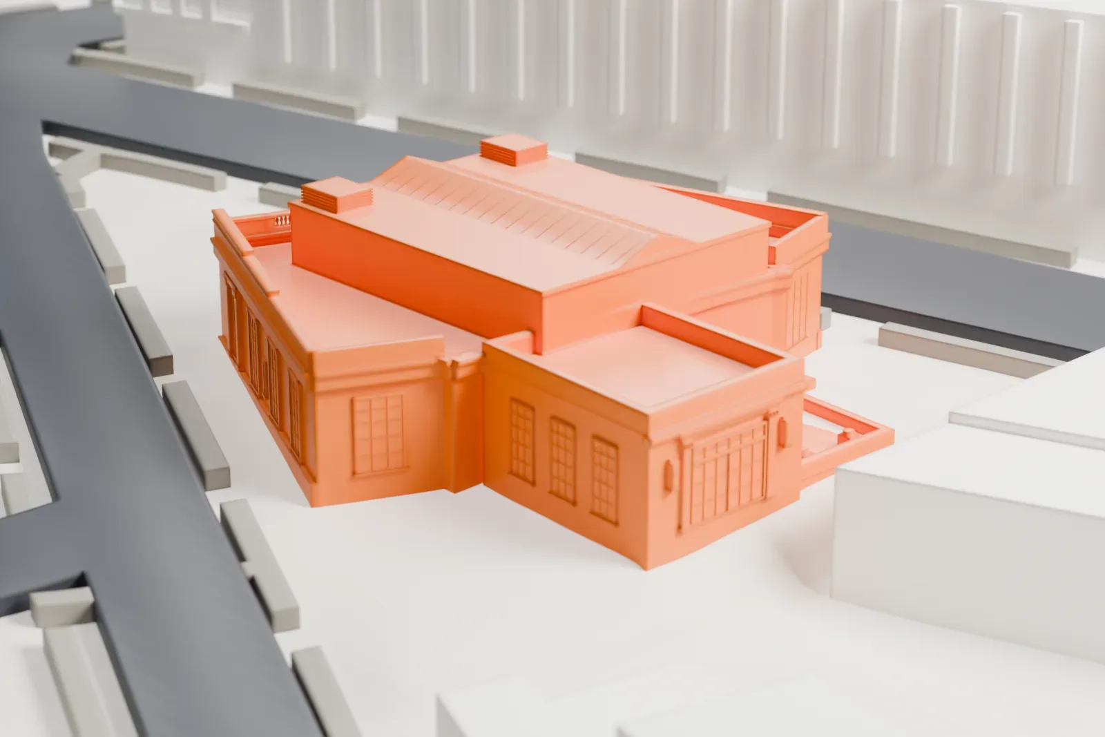 A white 3D print of the former Greenwich post office, a low building with a curved columned front and a flat roof, on a street corner beside a small park.