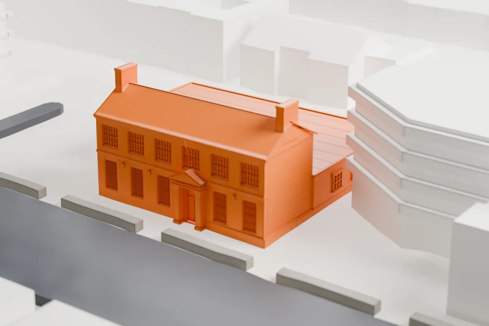 A white 3D print of the United States Post Office in Kensington, a two-story brick building with a pitched roof and a low flat-roofed wing, among larger buildings and streets.