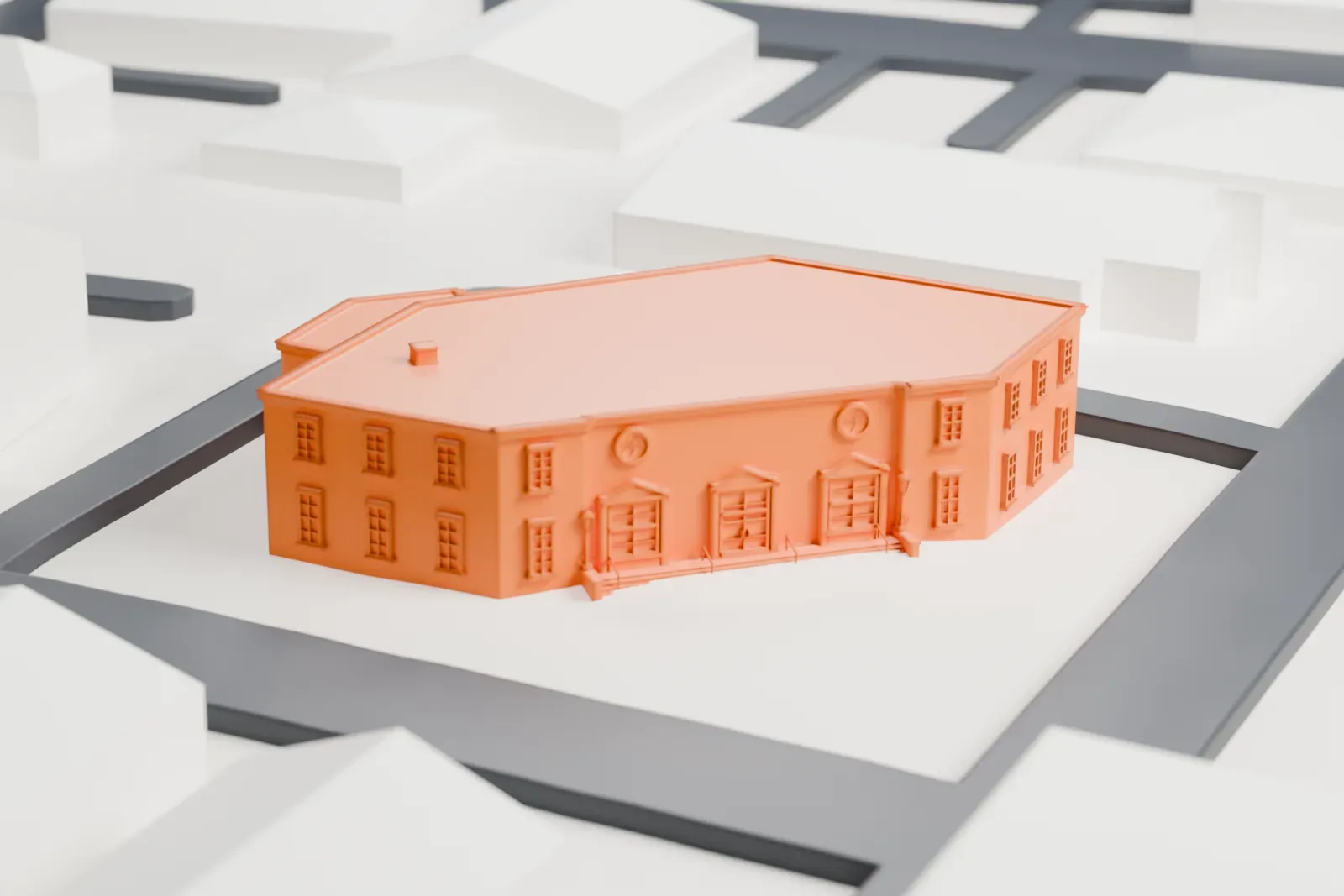 A white 3D print of a two-story post office with an angled corner facade and a lower wing, among streets and nearby buildings.