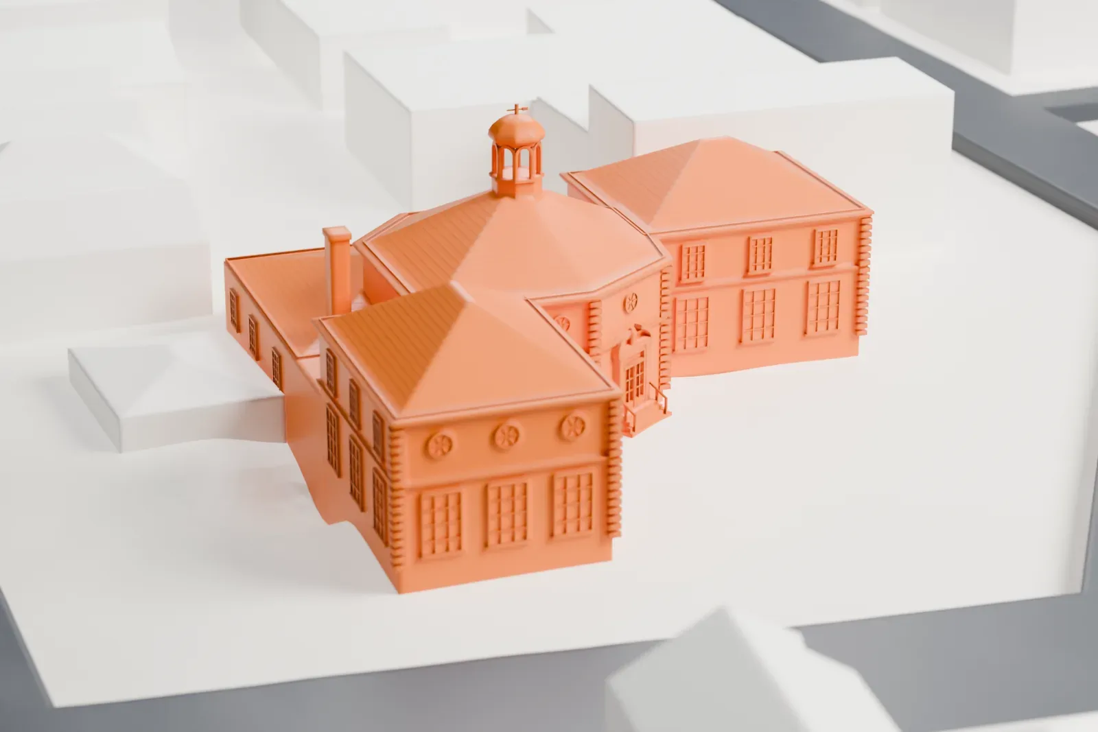 A white 3D print of the Oyster Bay Post Office, a building with an octagonal domed center and hipped-roof wings, on a street corner among smaller buildings.