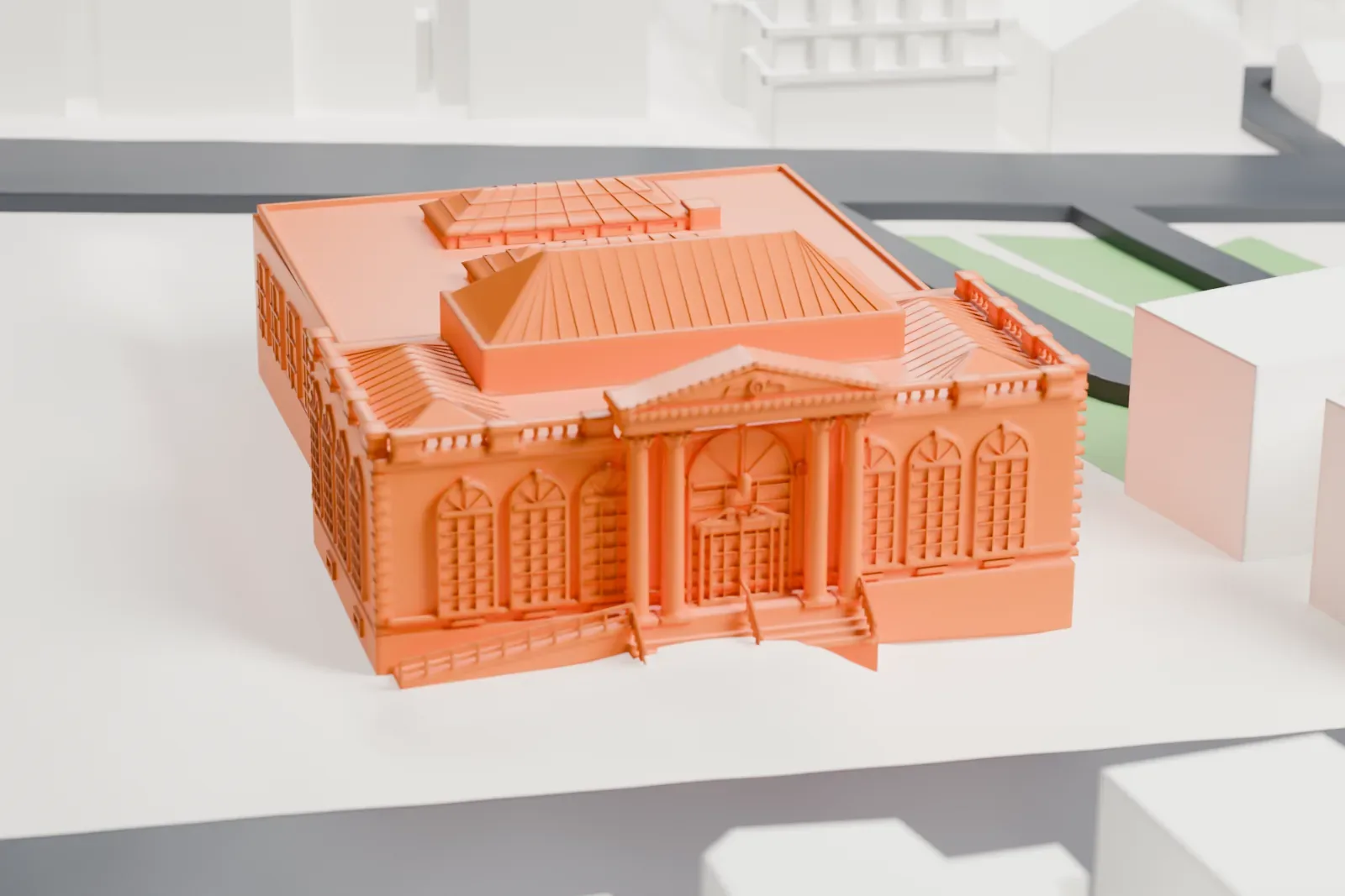 A white 3D print of the Port Chester post office, a one-story building with a columned portico at the front, standing among larger buildings and streets.