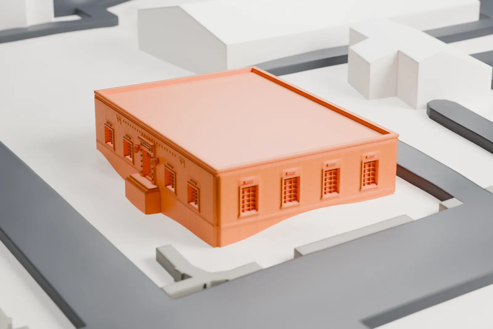 A white 3D print of the United States Post Office in Rye, a squat one-story brick building with a flat roof, beside streets and a few neighboring buildings.
