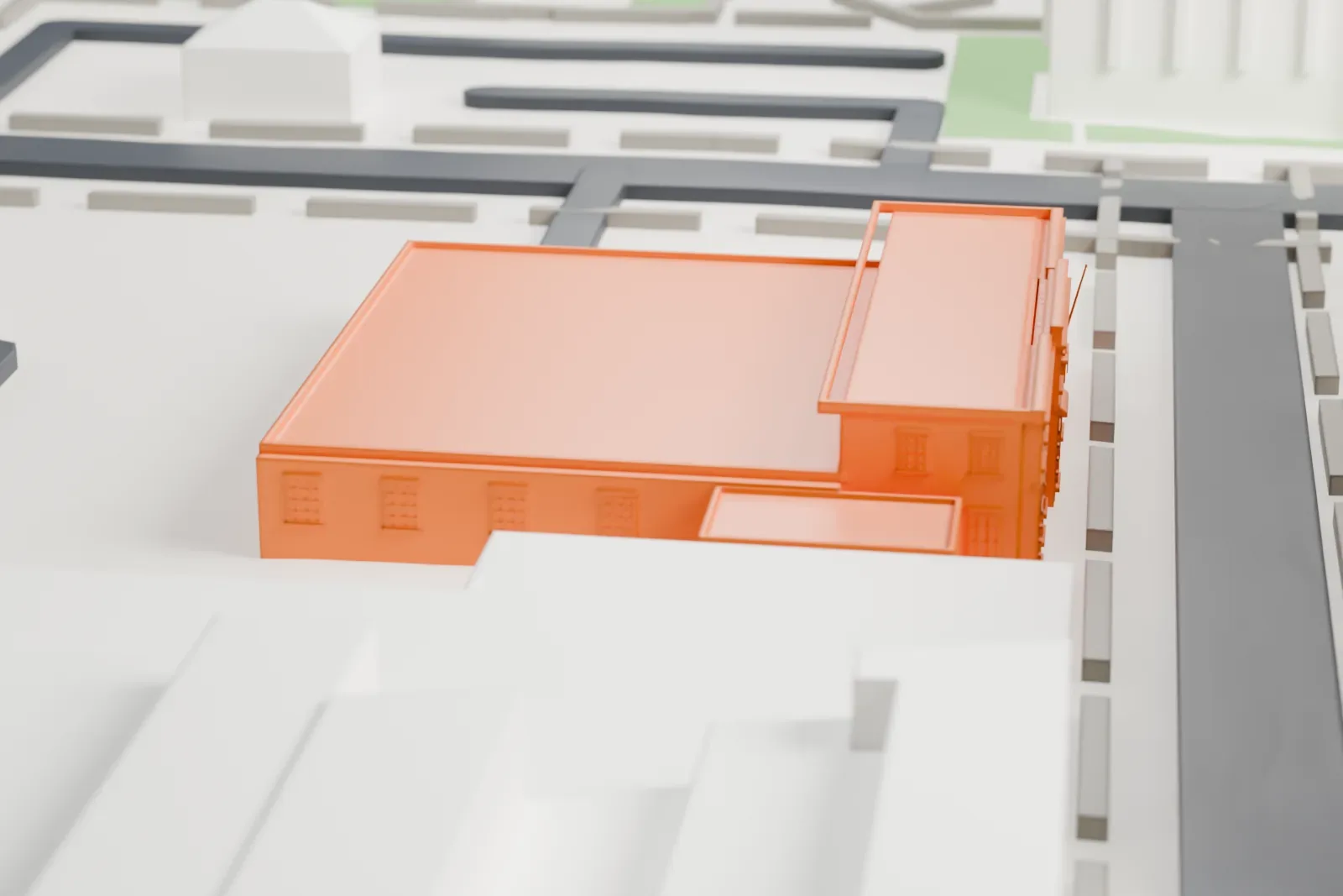 A white 3D print of the Williamsburg post office, a two-story flat-roofed building with a raised central section, beside streets and taller buildings.