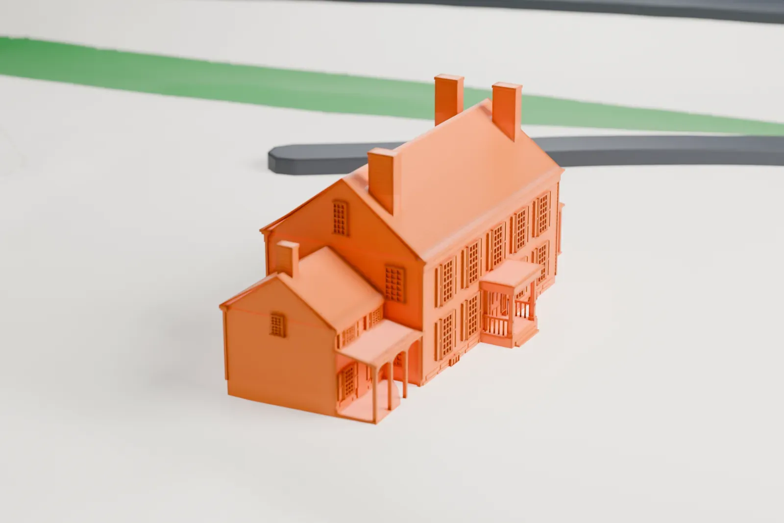 A white 3D print of the Van Horne House, a two-story house with a pitched roof, chimneys and porches, standing in open ground beside curving roads.
