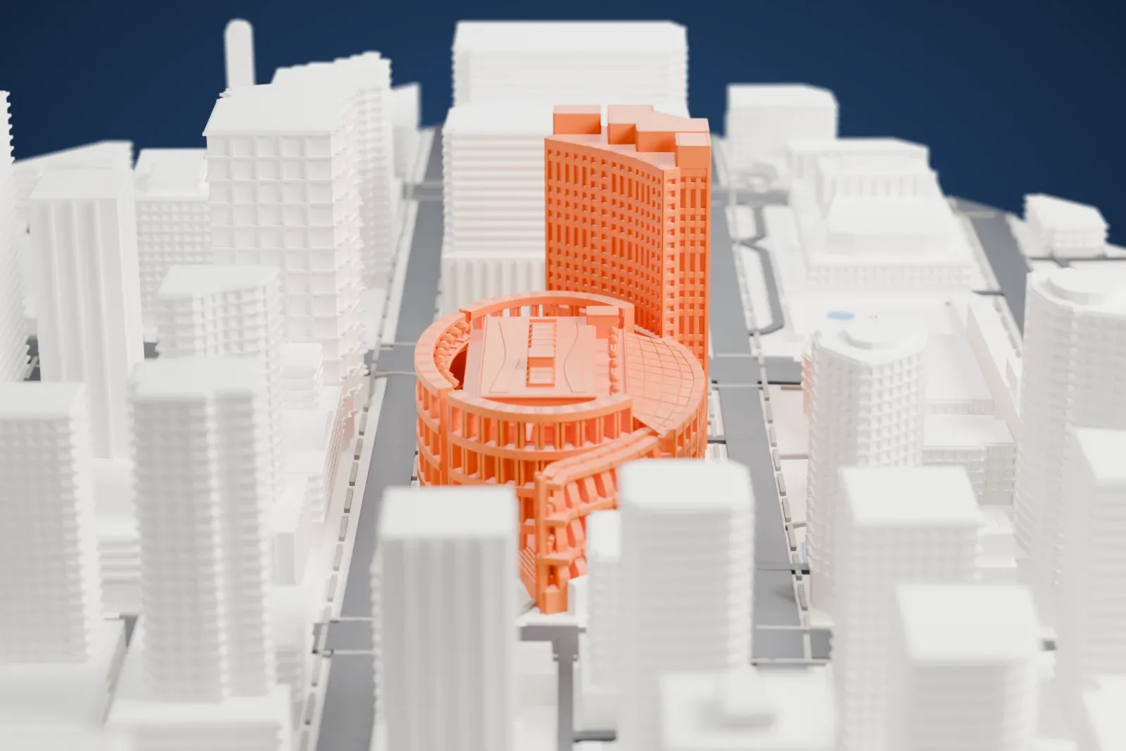 A white 3D print of the Vancouver Public Library Central Library, an oval colonnaded building beside a tall rectangular block, among downtown high-rises.