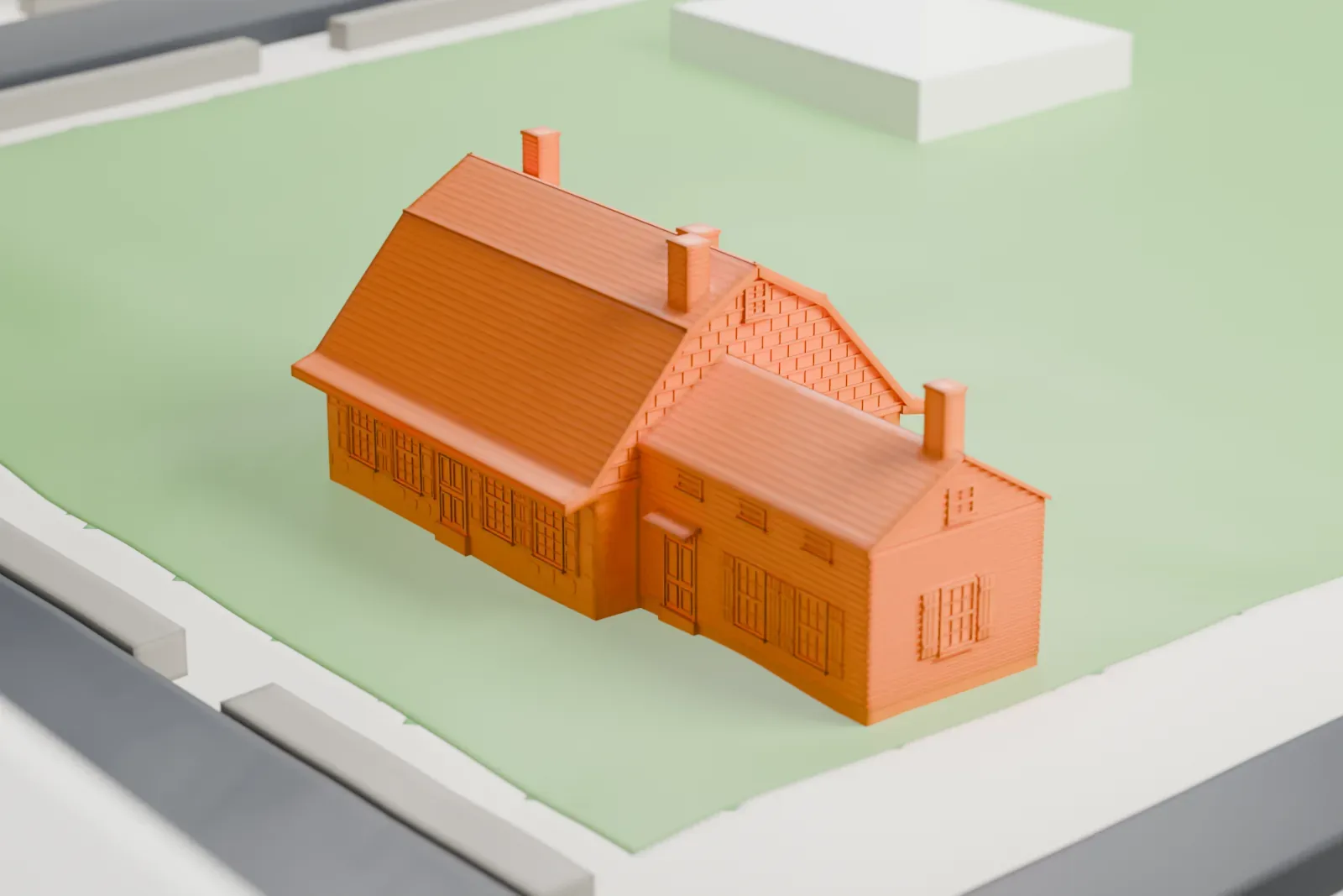 A white 3D print of the Vander Ende–Onderdonk House, a long low house with a steep roof and several chimneys, on a green lot beside a street.