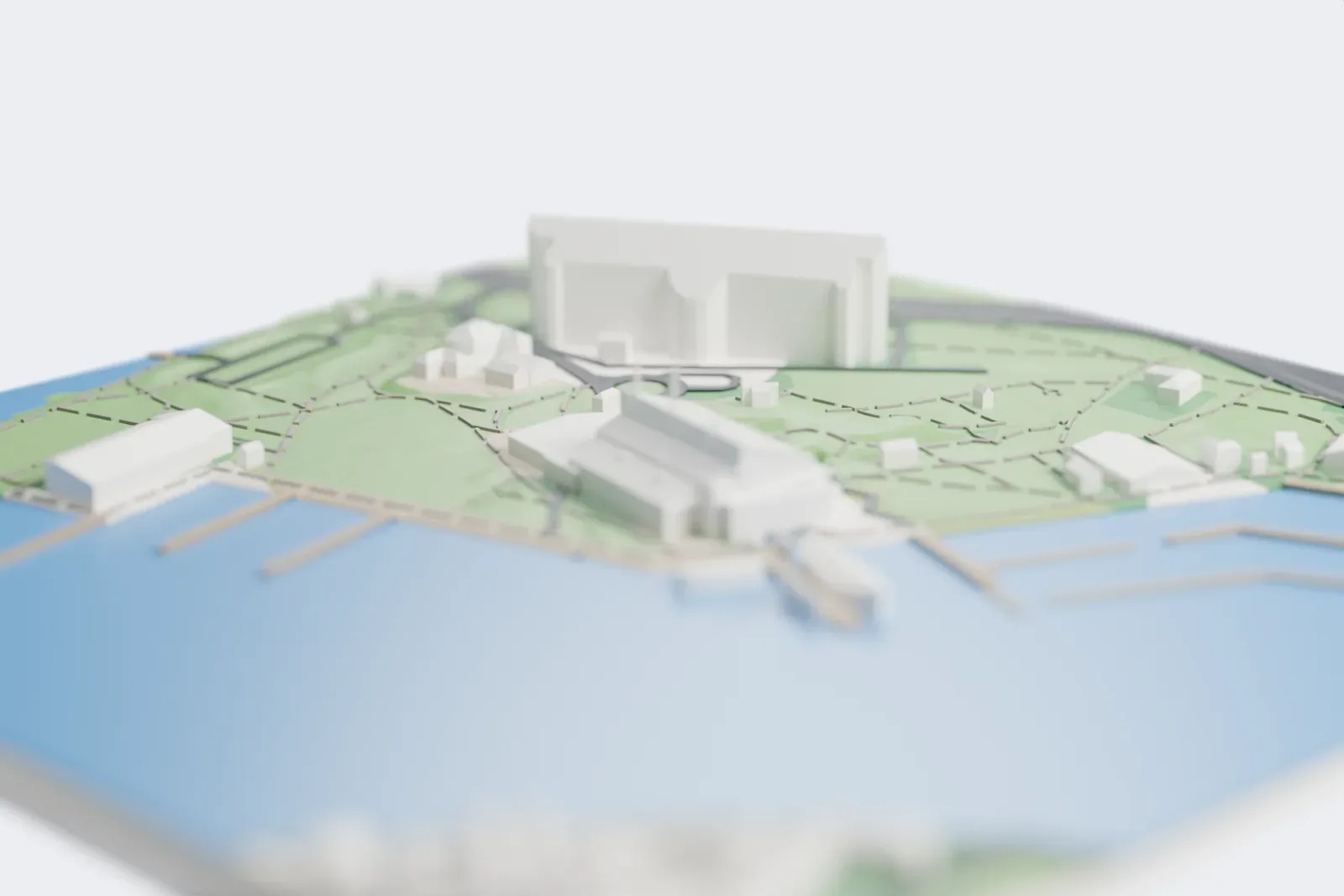 A white 3D print of the Vasa Museum, a large sloping roof with three tall masts on the waterfront, with piers, moored ships, park paths and lawns around it.