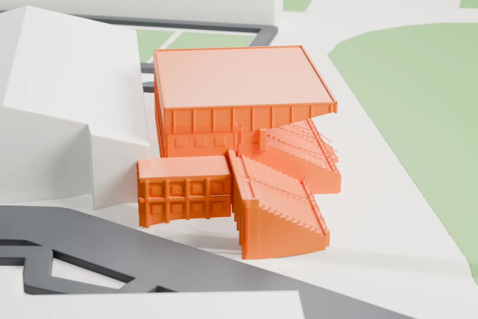 A white 3D print of the Victoria Stadium main stand, a covered grandstand with a deep wedge roof and a stepped rake on a white plinth, with an uncovered wing at one end, among the surrounding streets and buildings.