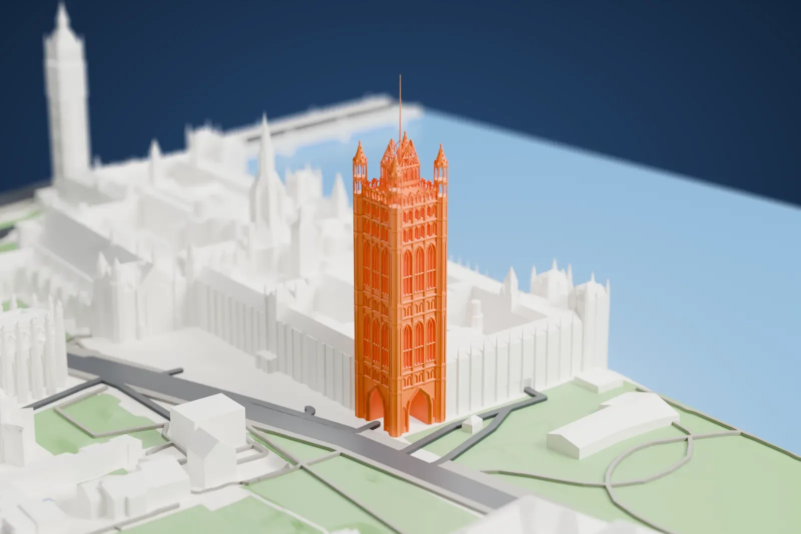 A white 3D print of the Victoria Tower rising beside the surrounding buildings of Westminster in London.