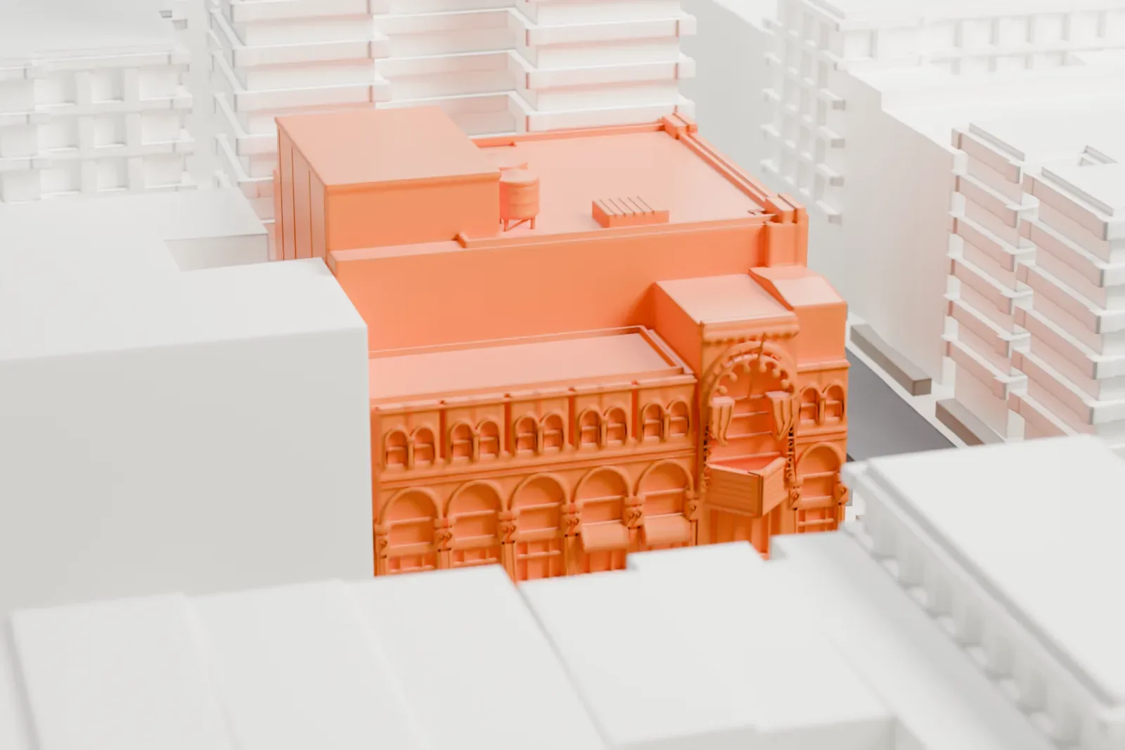 A white 3D print of Village East by Angelika, a low theater building with an arched front, among taller buildings and streets in the East Village.