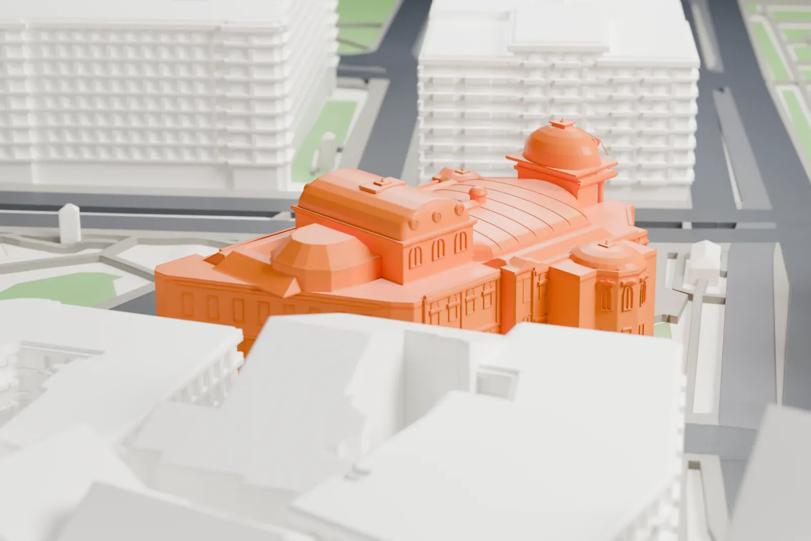 A white 3D print of the Volkstheater among the surrounding streets and buildings of Vienna.