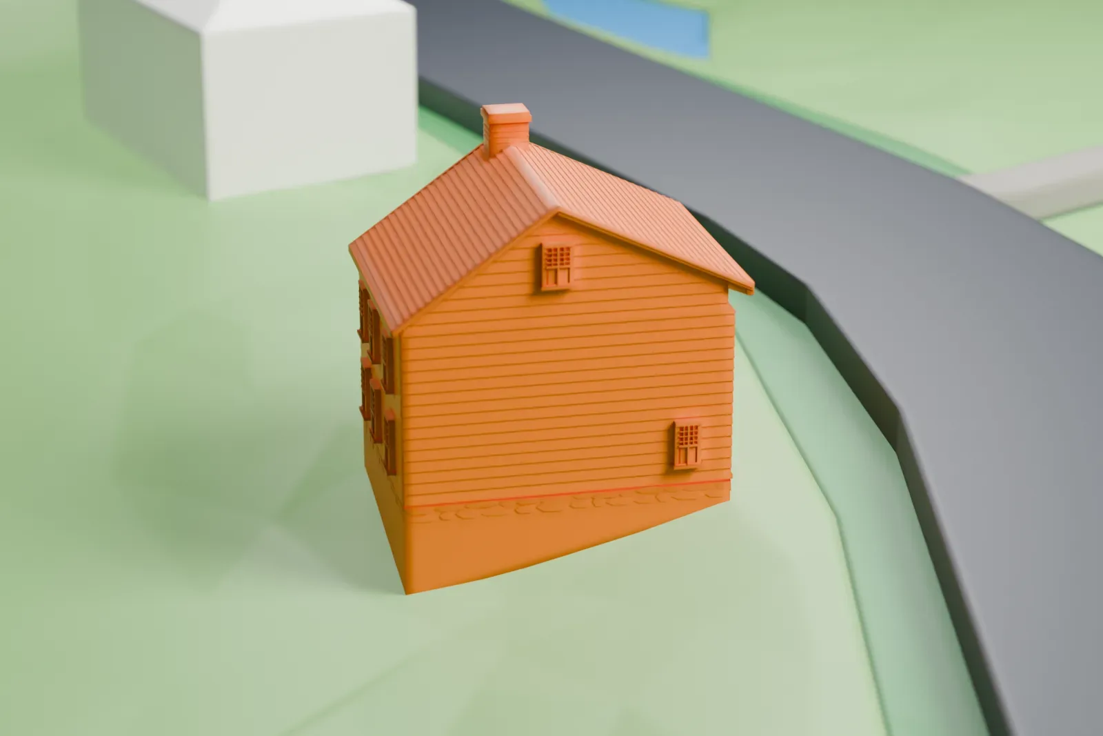 A white 3D print of the Voorlezer's House, a small pitched-roof house beside a road, with green open ground around it.